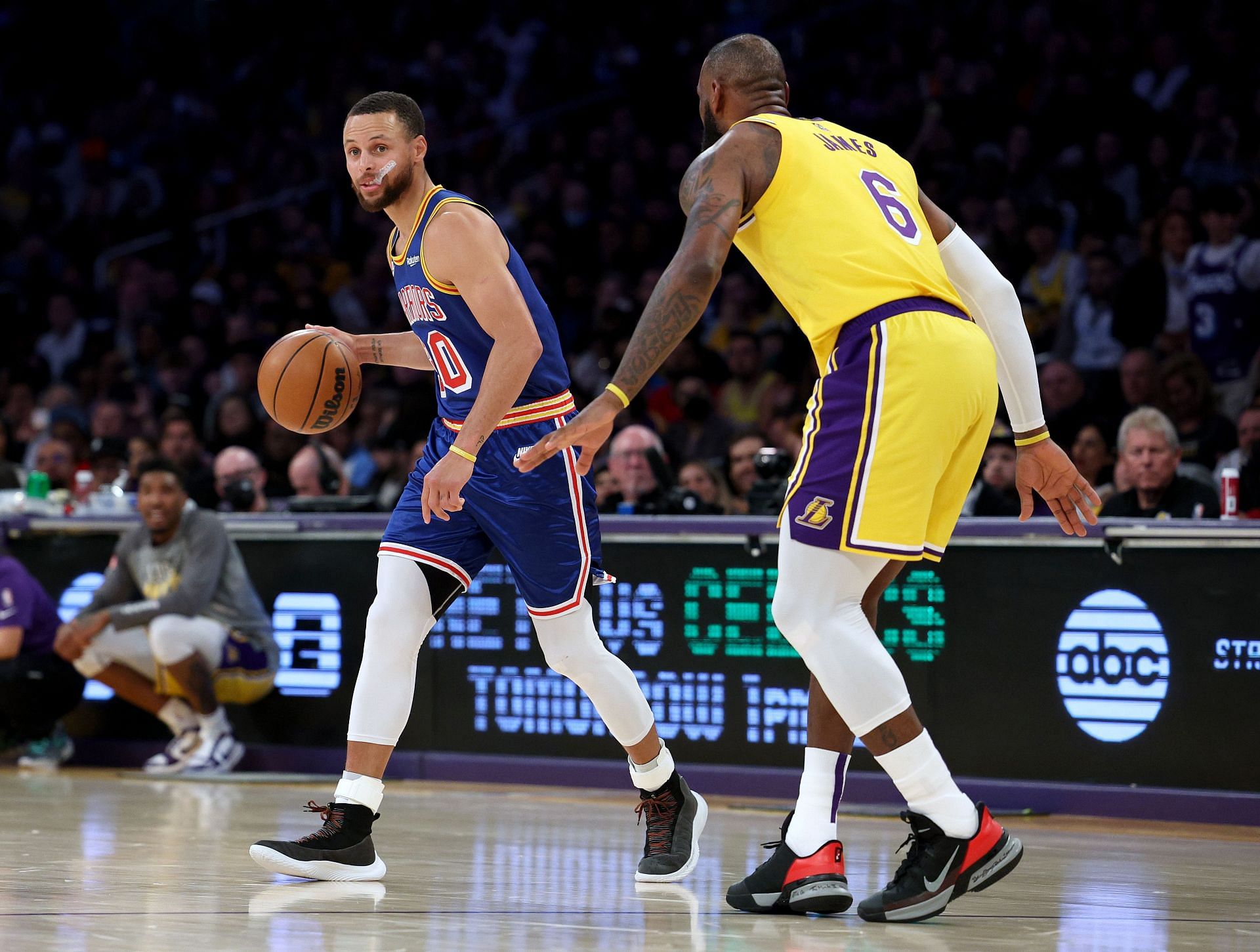 Steph Curry #30 of the Golden State Warriors dribbles in front of LeBron James #6 of the Los Angeles Lakers during a 124-116 Lakers win at Crypto.com Arena on March 05, 2022 in Los Angeles, California.
