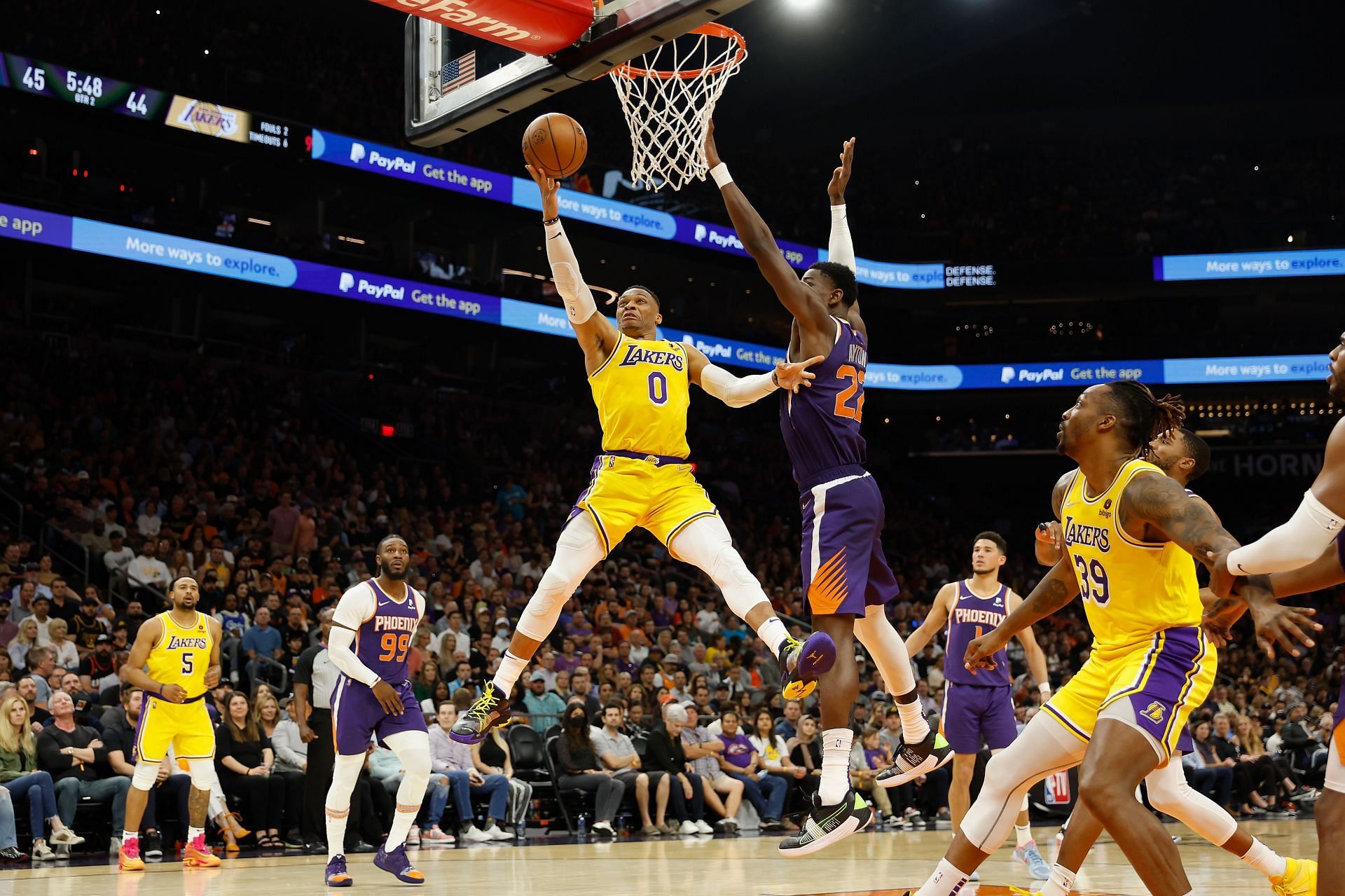 Russell Westbrook #0 of the Los Angeles Lakers lays up a shot past Deandre Ayton #22 of the Phoenix Suns during the first half of the NBA game at Footprint Center on April 05, 2022 in Phoenix, Arizona. The Suns defeated the Lakers 121-110.