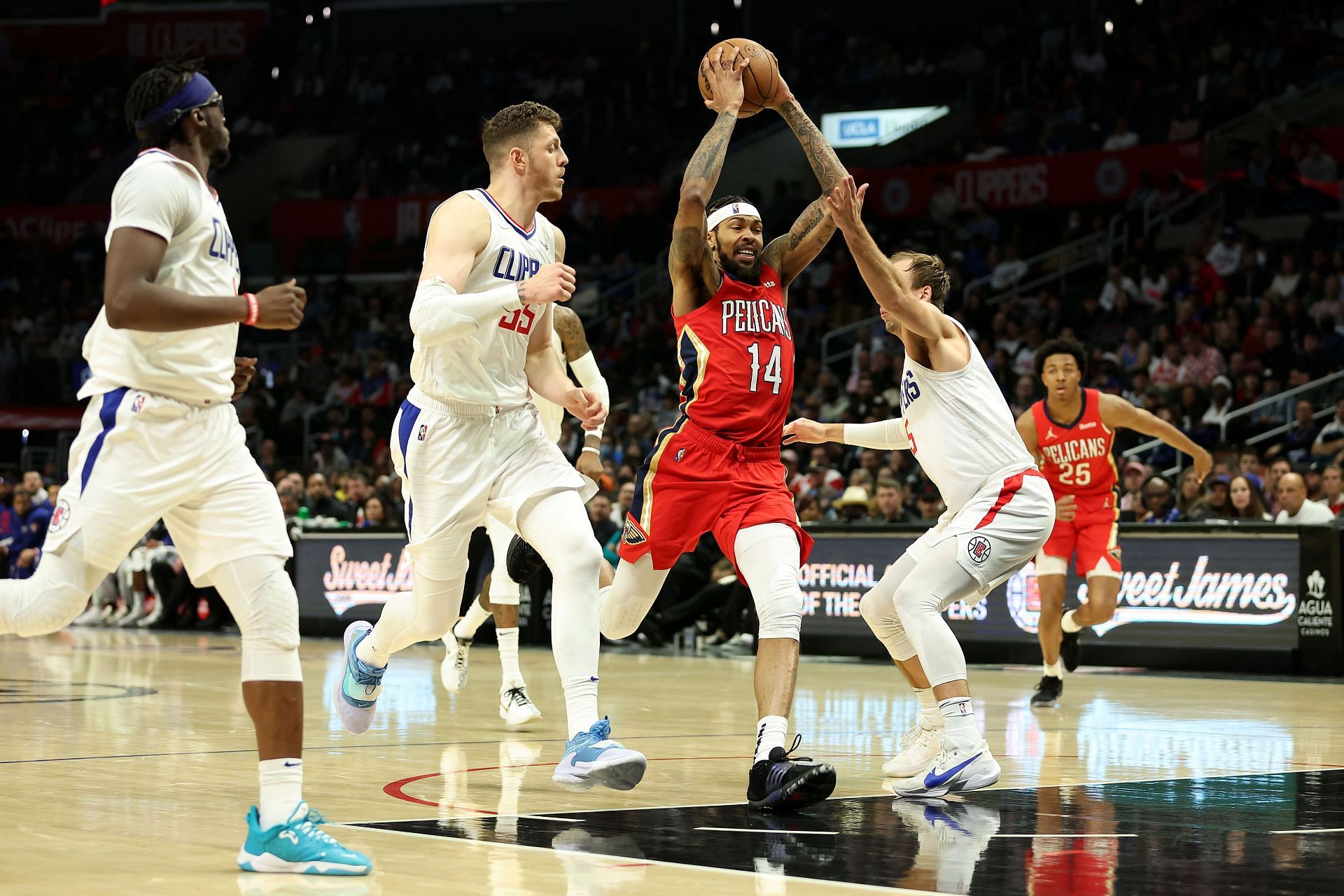 LA Clippers players defend against Brandon Ingram #14 of the New Orleans Pelicans