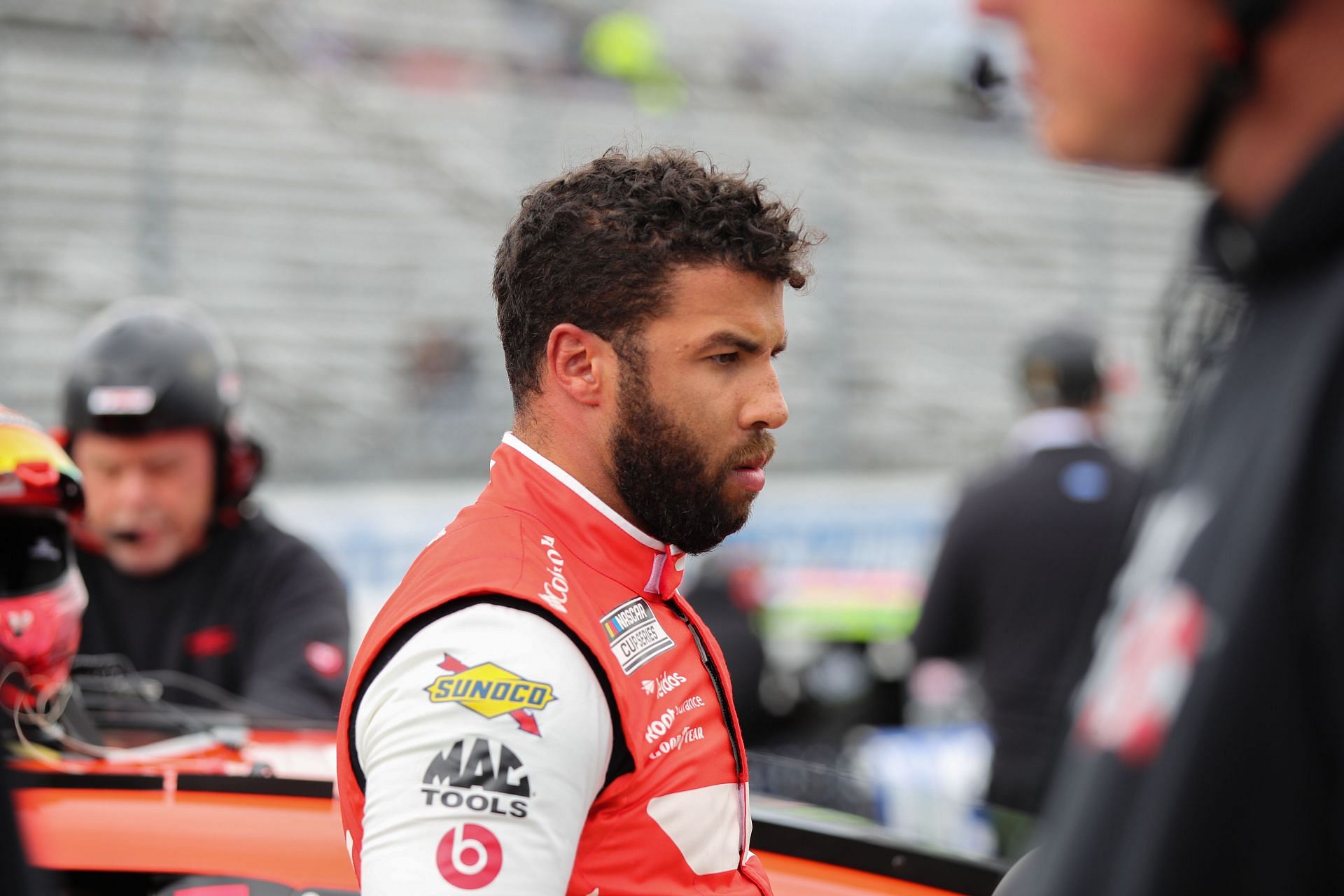 Bubba Wallace waits on the grid during practice for the NASCAR Cup Series Blue-Emu Maximum Pain Relief 400 at Martinsville Speedway.