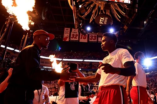 Jimmy Butler of the Miami Heat high fives Victor Oladipo