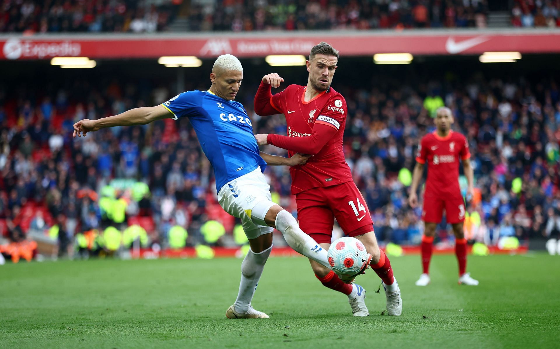 Richarlison and Jordan Henderson tussle it out.