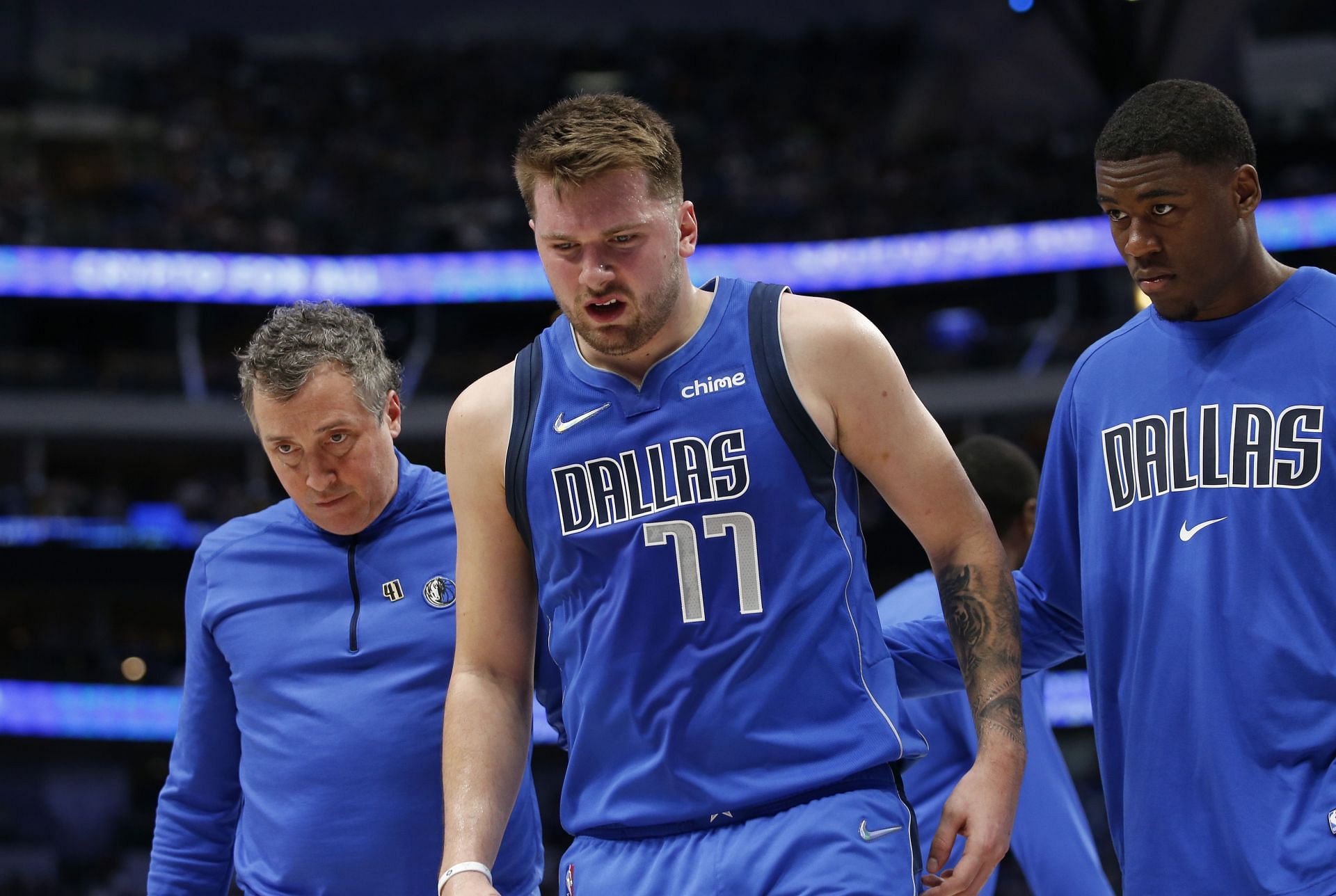 Luka Doncic No. 77 of the Dallas Mavericks leaves the court with an injury.