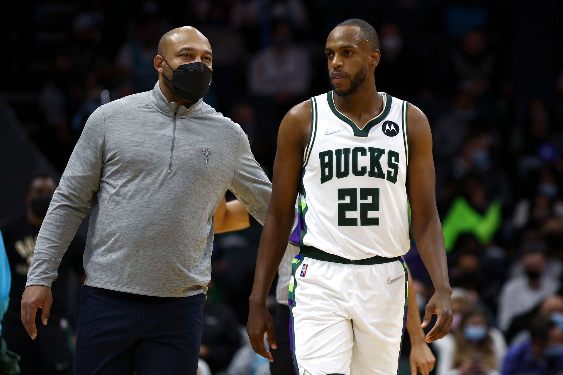 Acting head coach Darvin Ham of the Milwaukee Bucks speaks with Khris Middleton No. 22 during the first quarter of the game against the Charlotte Hornets.