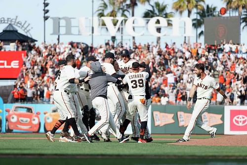 Austin Slater celebrates with his teammates after getting the walk-off double. Photo Credit: Santiago Mejia / The Chronicle