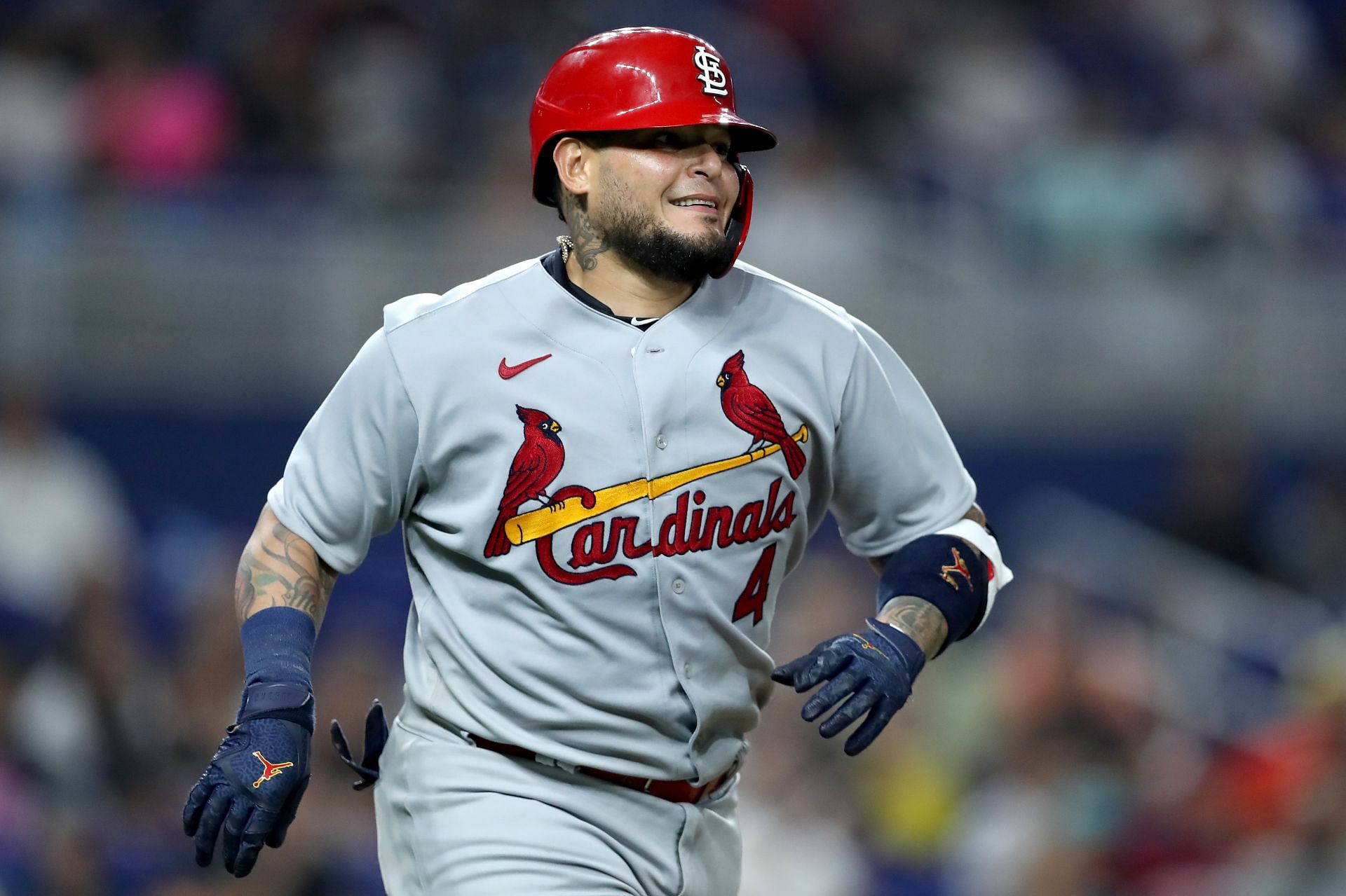 Yadier Molina runs to first base after he lines a base hit into right field. 