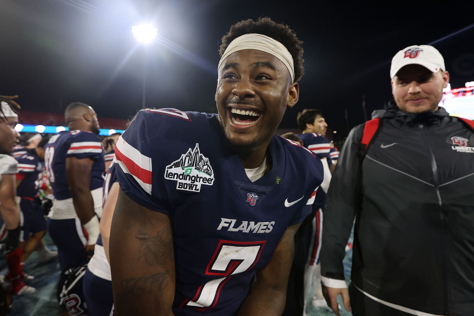 Malik Willis #7 of the Liberty Flames celebrates after winning the LendingTree Bowl against the Eastern Michigan Eagles at Hancock Whitney Stadium on December 18, 2021 in Mobile, Alabama.