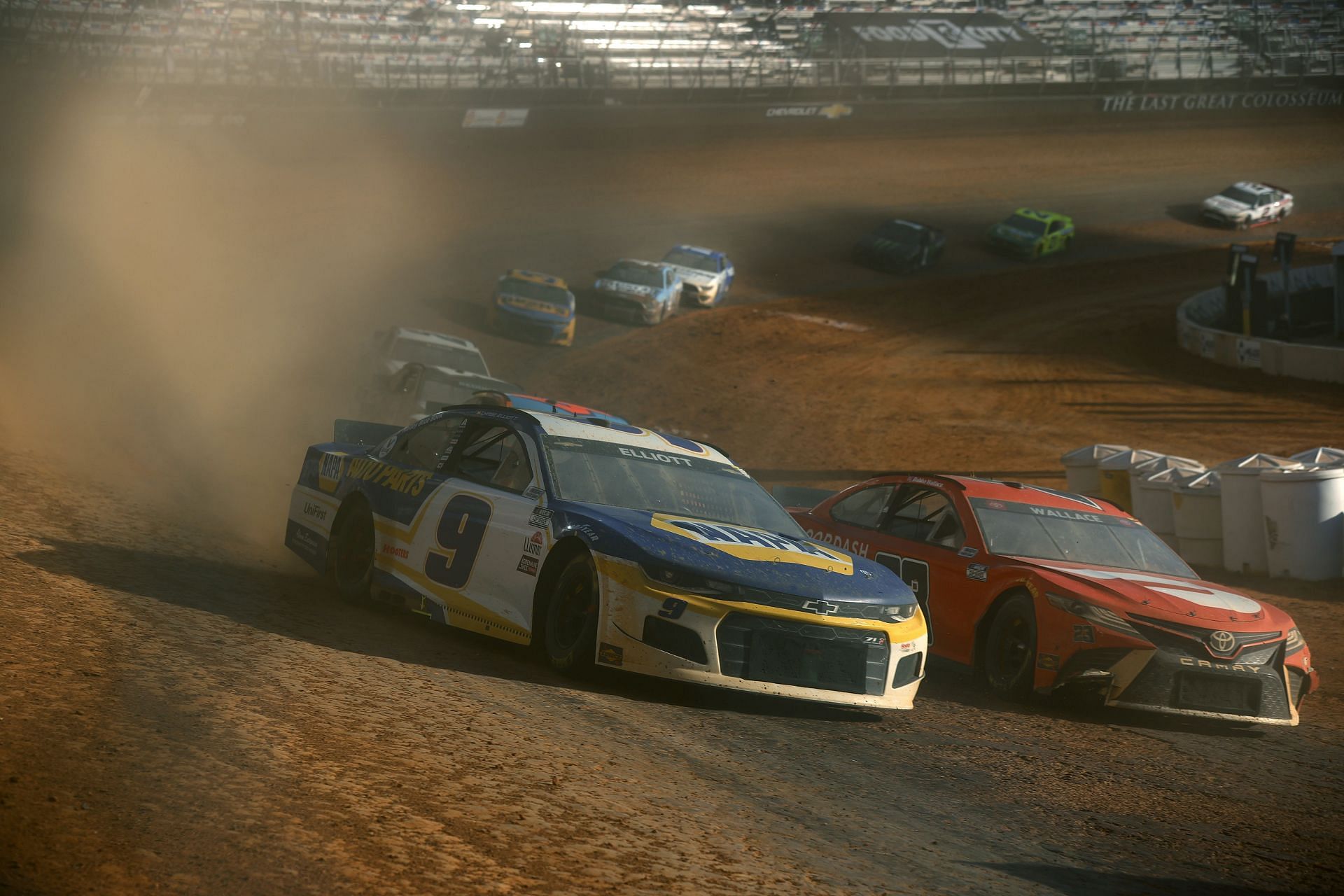 Chase Elliott in the No. 9 NAPA Auto Parts Chevrolet races Bubba Wallace in the No. 23 DoorDash Toyota during the 2021 NASCAR Cup Series Food City Dirt Race at Bristol Motor Speedway in Tennessee. (Photo by Jared C. Tilton/Getty Images)