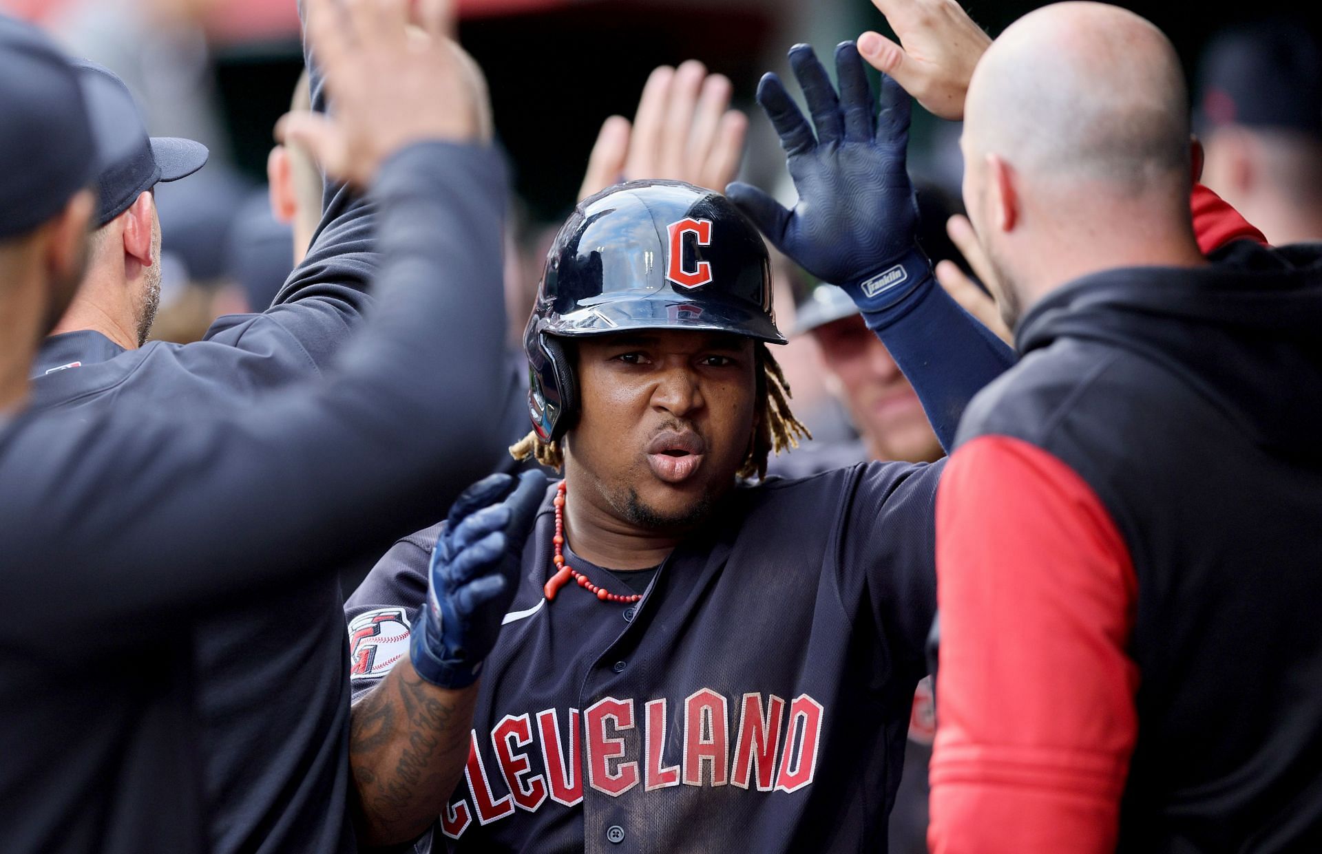 Jose Ramirez celebrates with his team after hitting a grand slam against the Reds