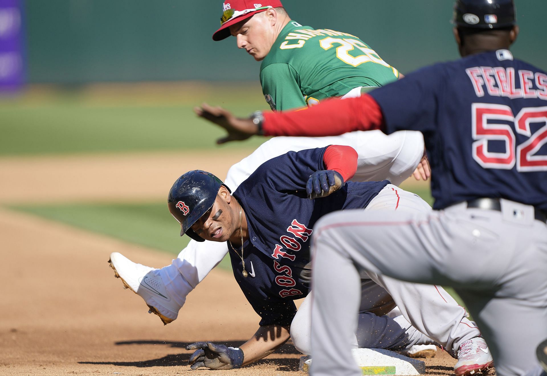 Rafael Devers slides into third base