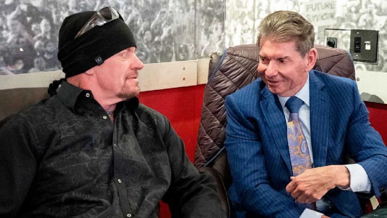 The Undertaker chatting with Vince McMahon backstage