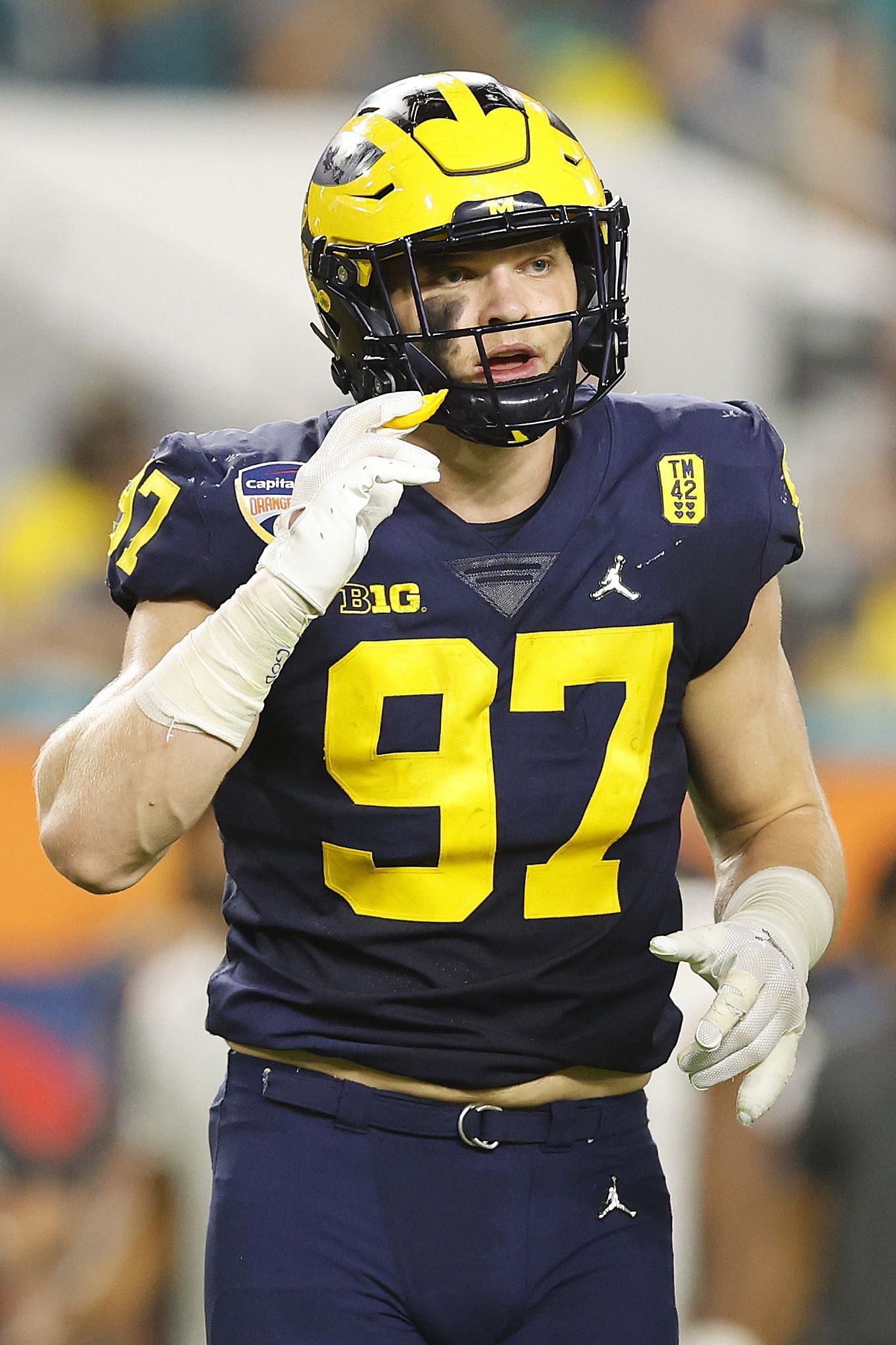 Aidan Hutchinson #97 of the Michigan Wolverines looks on against the Georgia Bulldogs in the Capital One Orange Bowl for the College Football Playoff semifinal game at Hard Rock Stadium on December 31, 2021 in Miami Gardens, Florida.