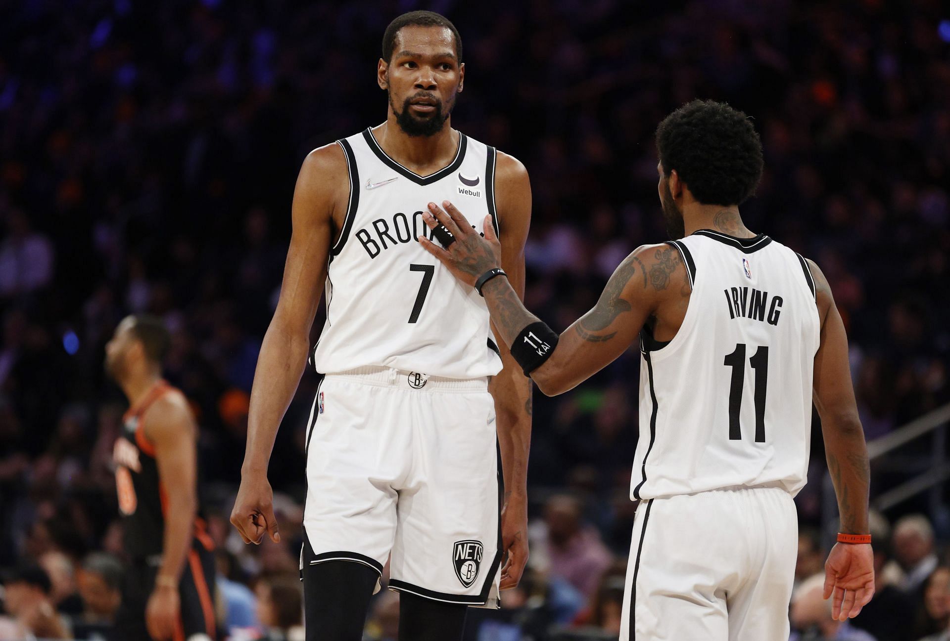 Kyrie Irving reacts with Kevin Durant of the Brooklyn Nets