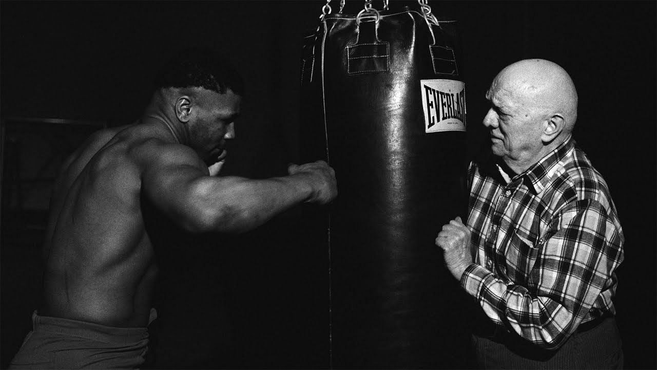 Mike Tyson and Cus D&#039;Amato (right). [Courtesy of YouTube]