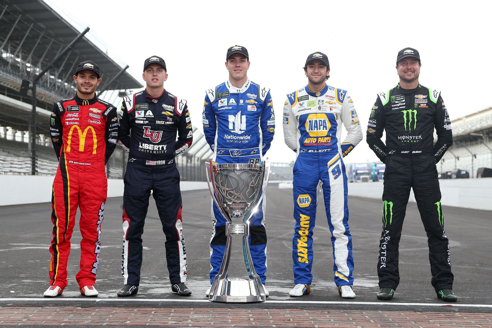 (L-R) Kyle Larson, William Byron, Alex Bowman, Chase Elliott, and Kurt Busch pose for a photo with the 2019 Monster Energy NASCAR Cup Series trophy following the Monster Energy NASCAR Cup Series Big Machine Vodka 400 at the Indianapolis Motor Speedway (Photo by Brian Lawdermilk/Getty Images)