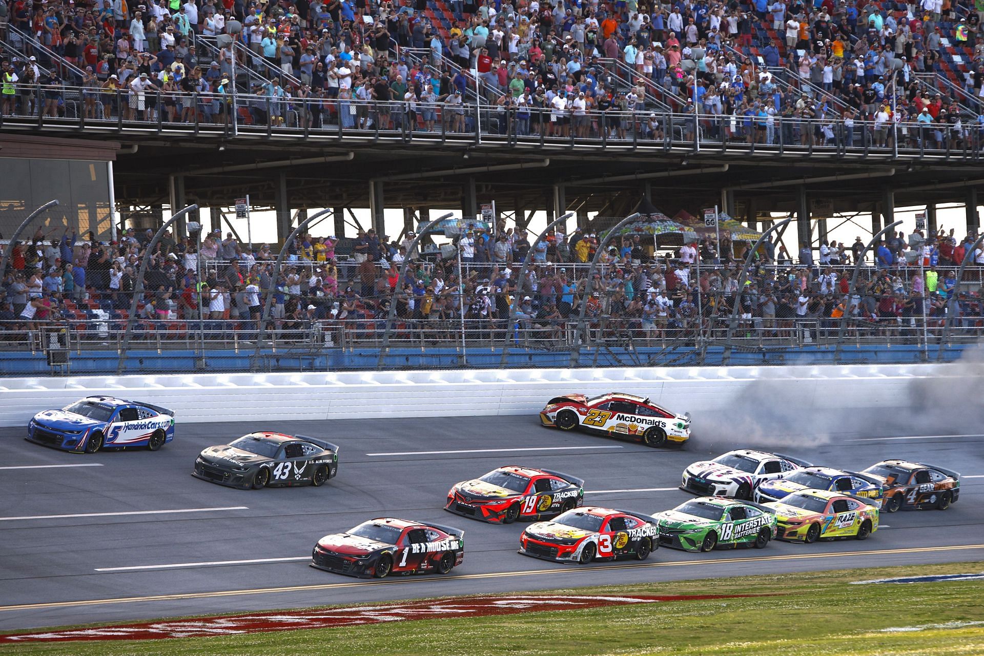 Bubba Wallace Jr. spins into the wall after an on-track incident as Ross Chastain leads the field to the end of the 2022 NASCAR Cup Series GEICO 500 at Talladega Superspeedway in Alabama. (Photo by Sean Gardner/Getty Images)