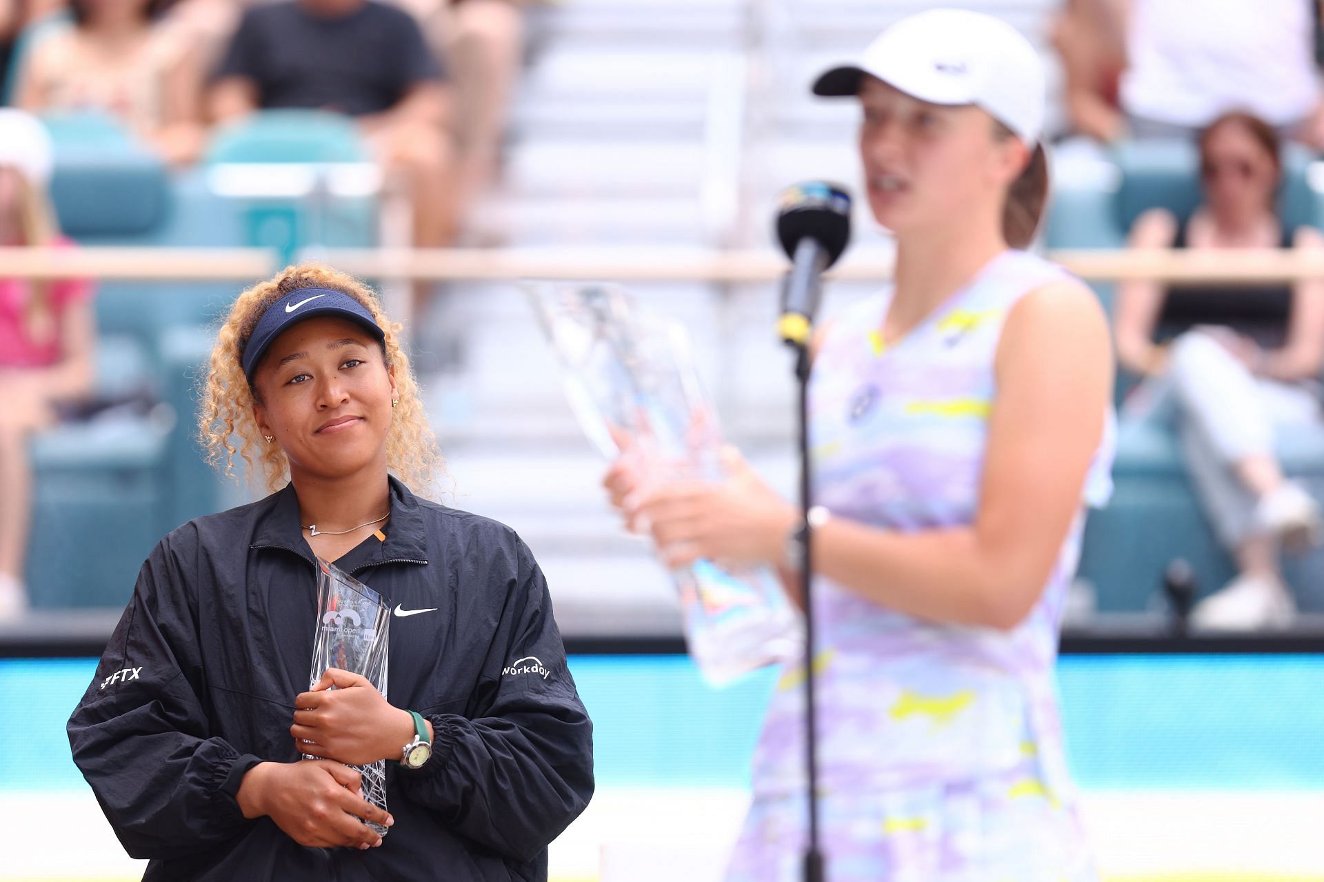 Miami Open runner-up Naomi Osaka looks on with a smile as champion Iga Swiatek delivers her speech