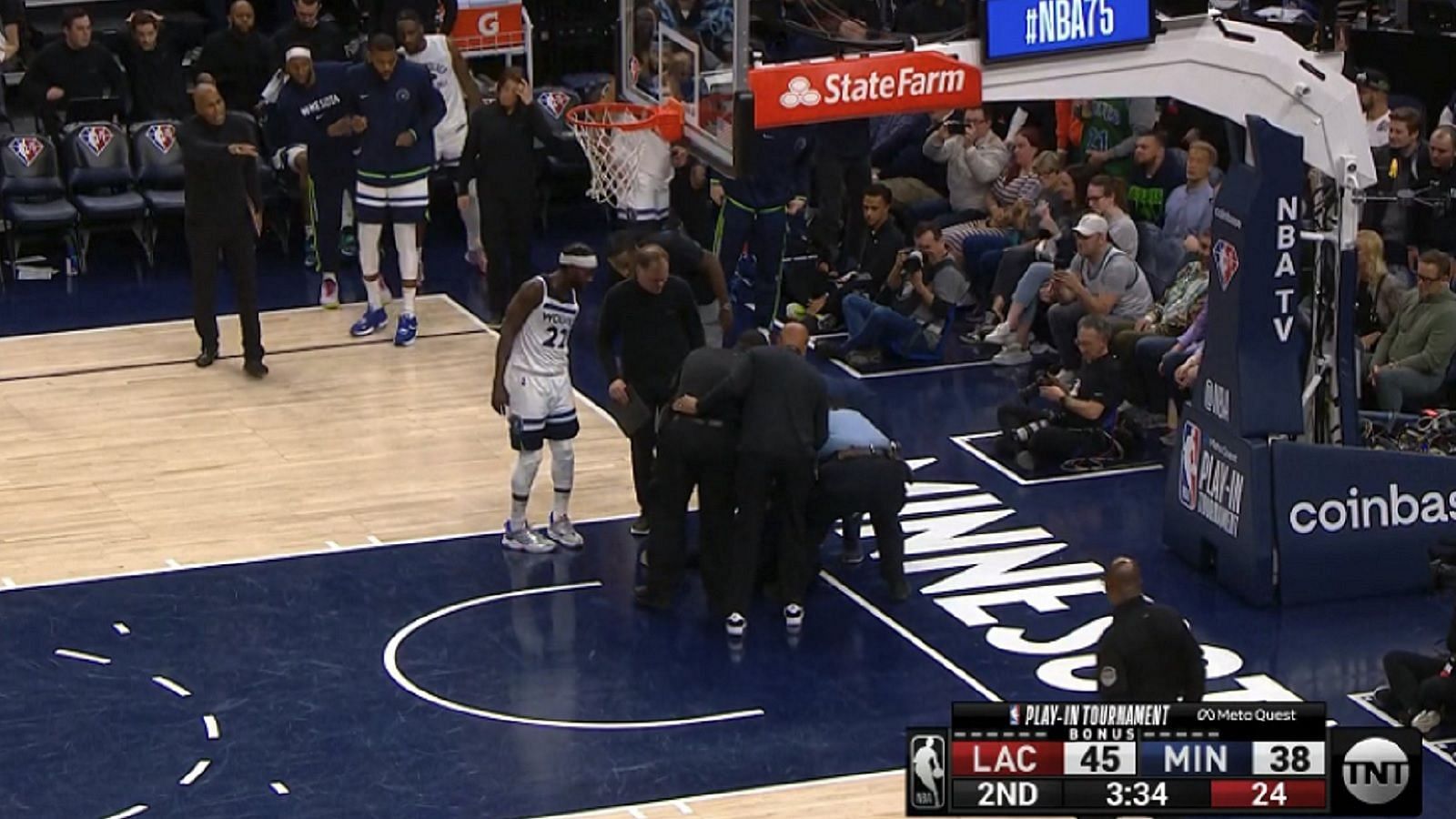 An unknown protester glued herself to the floor of the Target Center to briefly stop the game between the LA Clippers and Minnesota Timberwolves. [Photo: Larry Brown Sports]