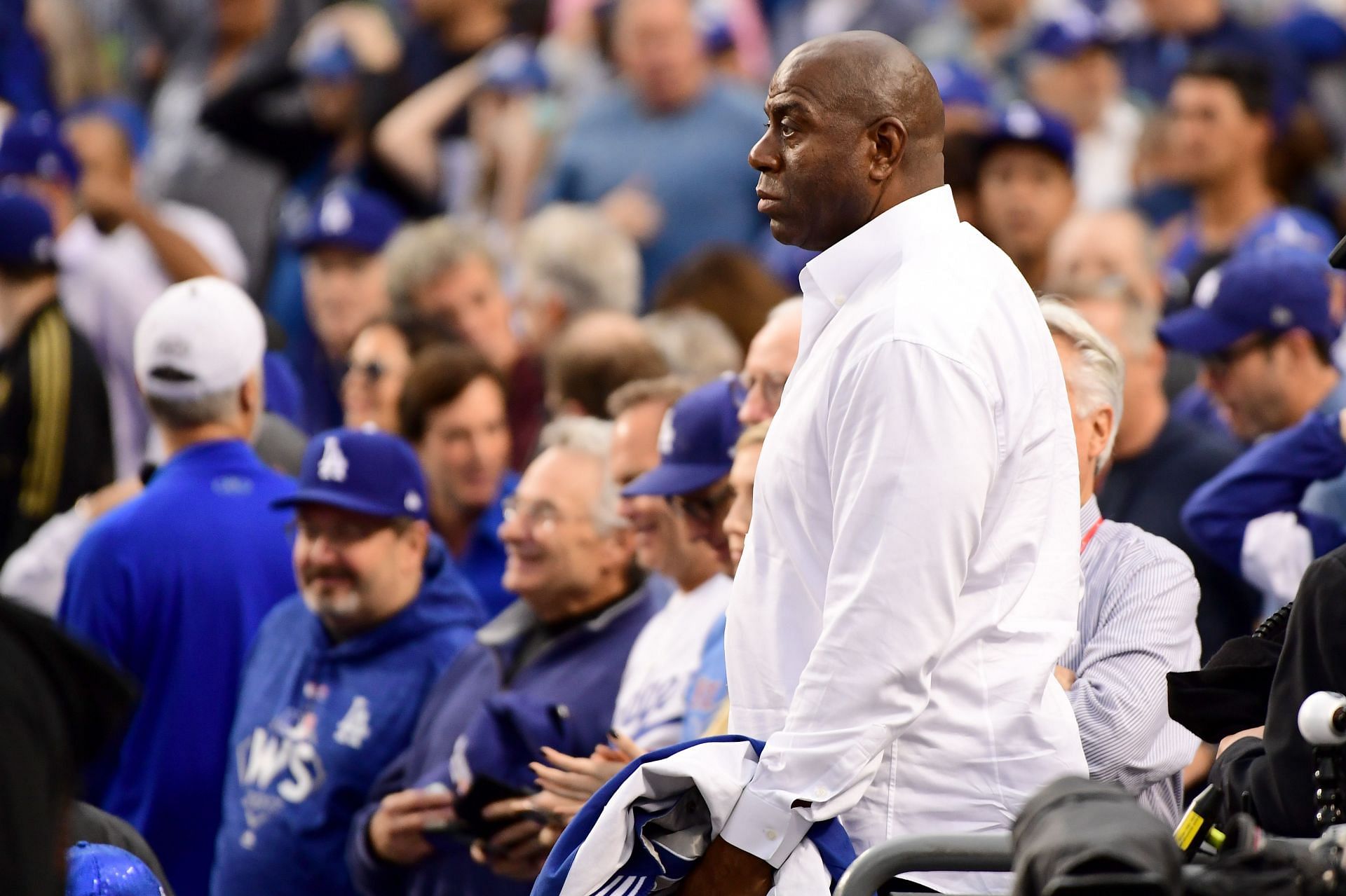 Earvin &#039;Magic&#039; Johnson looks on before Game &amp; of the 2017 World Series at Dodger Stadium.
