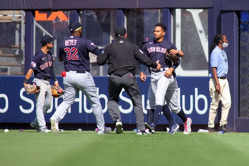 Fans throw debris onto field, at Guardians players following