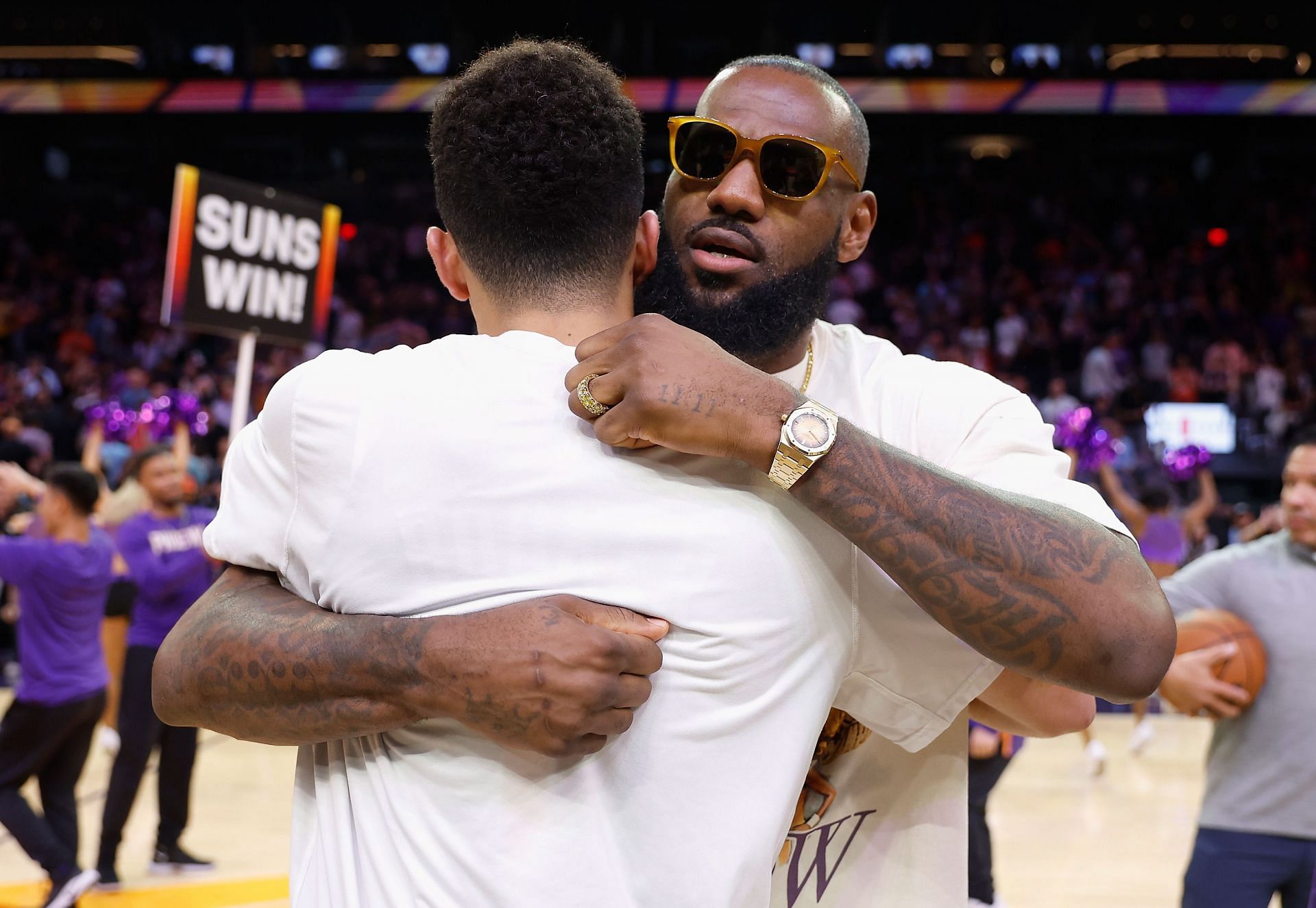 LeBron James and Devin Booker embrace after the game.
