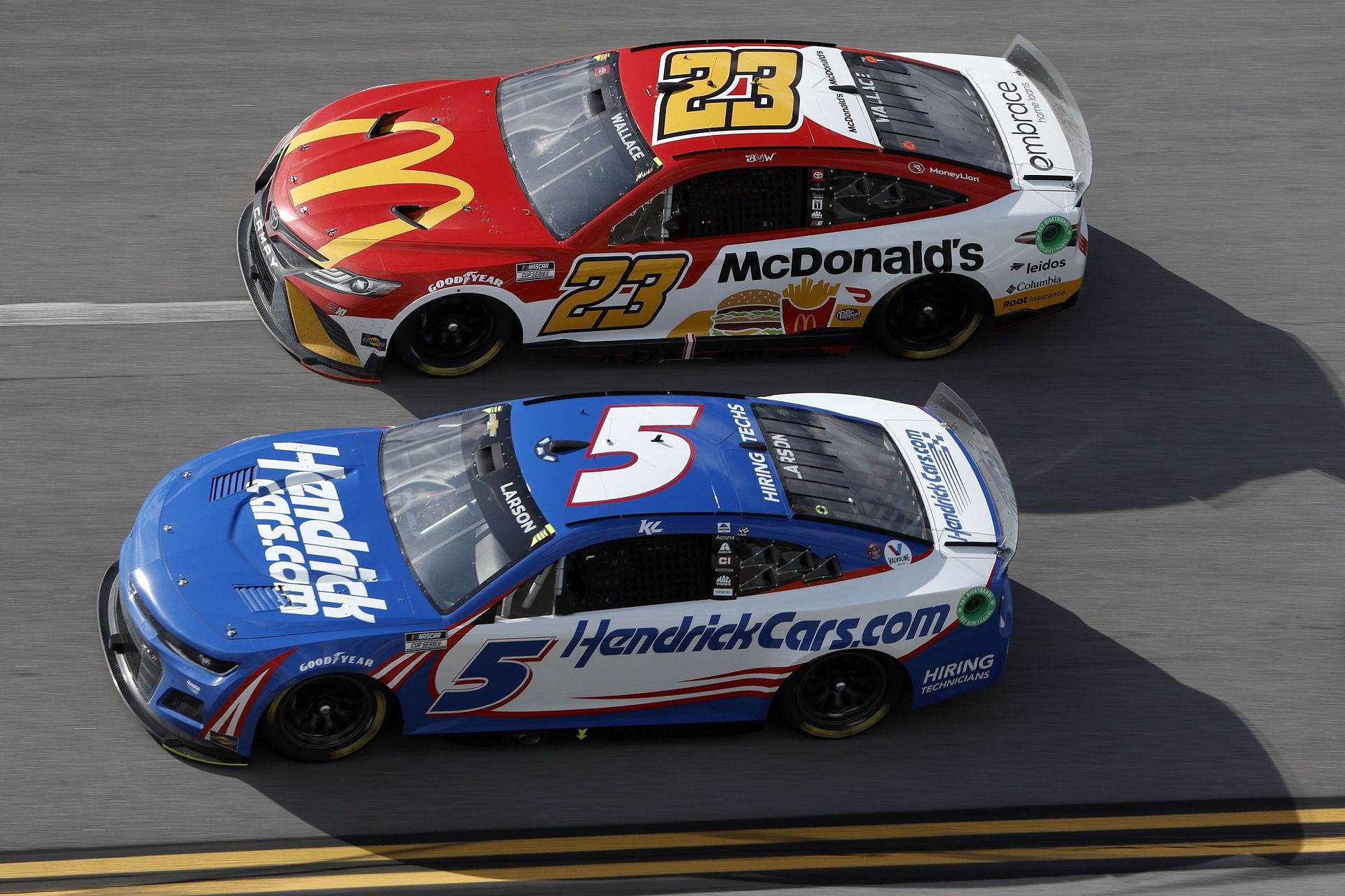 Kyle Larson in the #5 Chevrolet and Bubba Wallace in the #23 Toyota seen racing during the 2022 NASCAR Cup Series GEICO 500 at Talladega Superspeedway in Alabama (Photo by Sean Gardner/Getty Images)