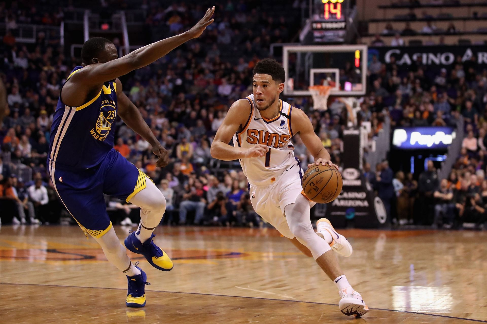 Draymond Green of the Golden State Warriors and Devin Booker of the Phoenix Suns.