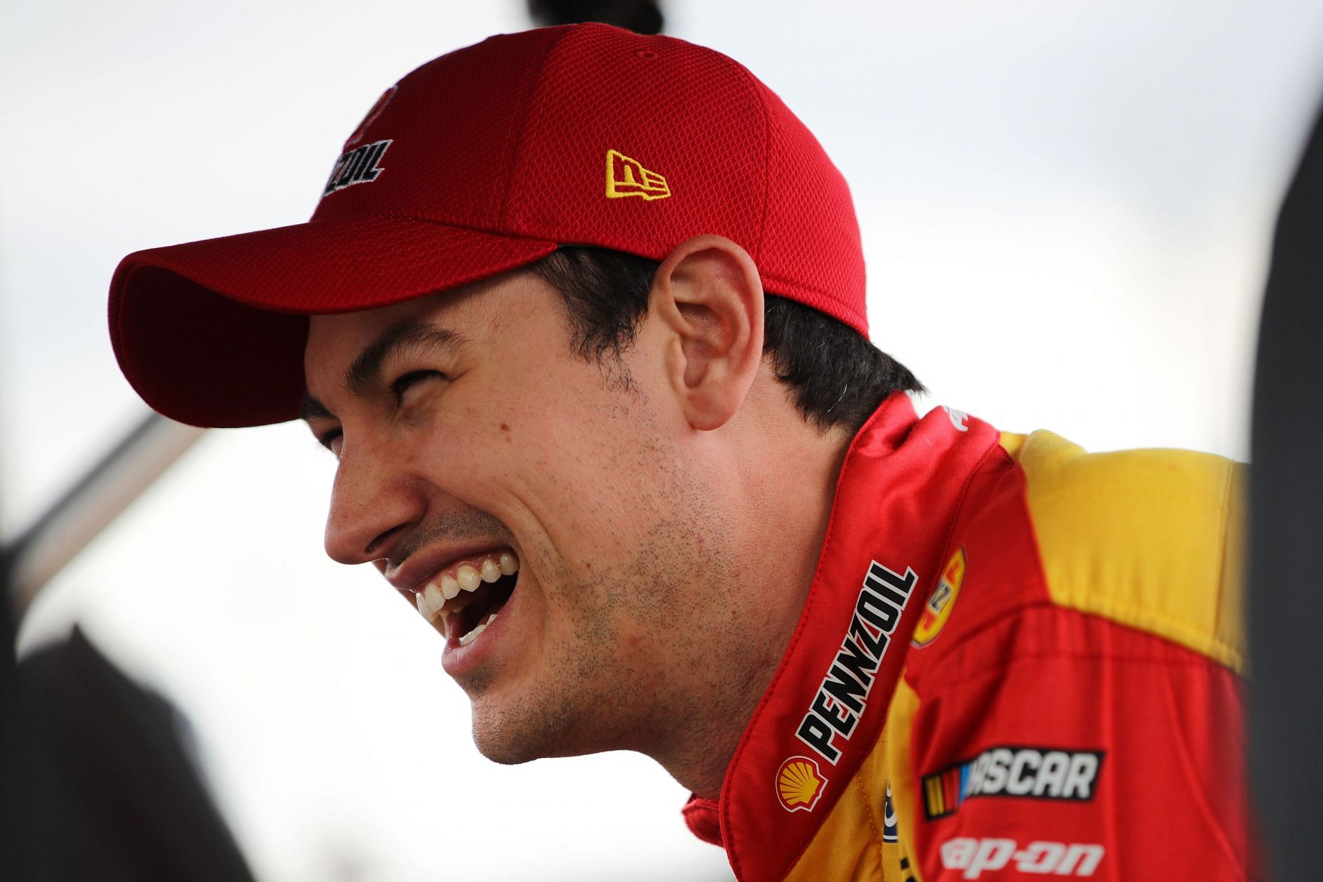Joey Logano laughs on the grid during practice for the NASCAR Cup Series Blue-Emu Maximum Pain Relief 400 at Martinsville Speedway. (Photo by Meg Oliphant/Getty Images)