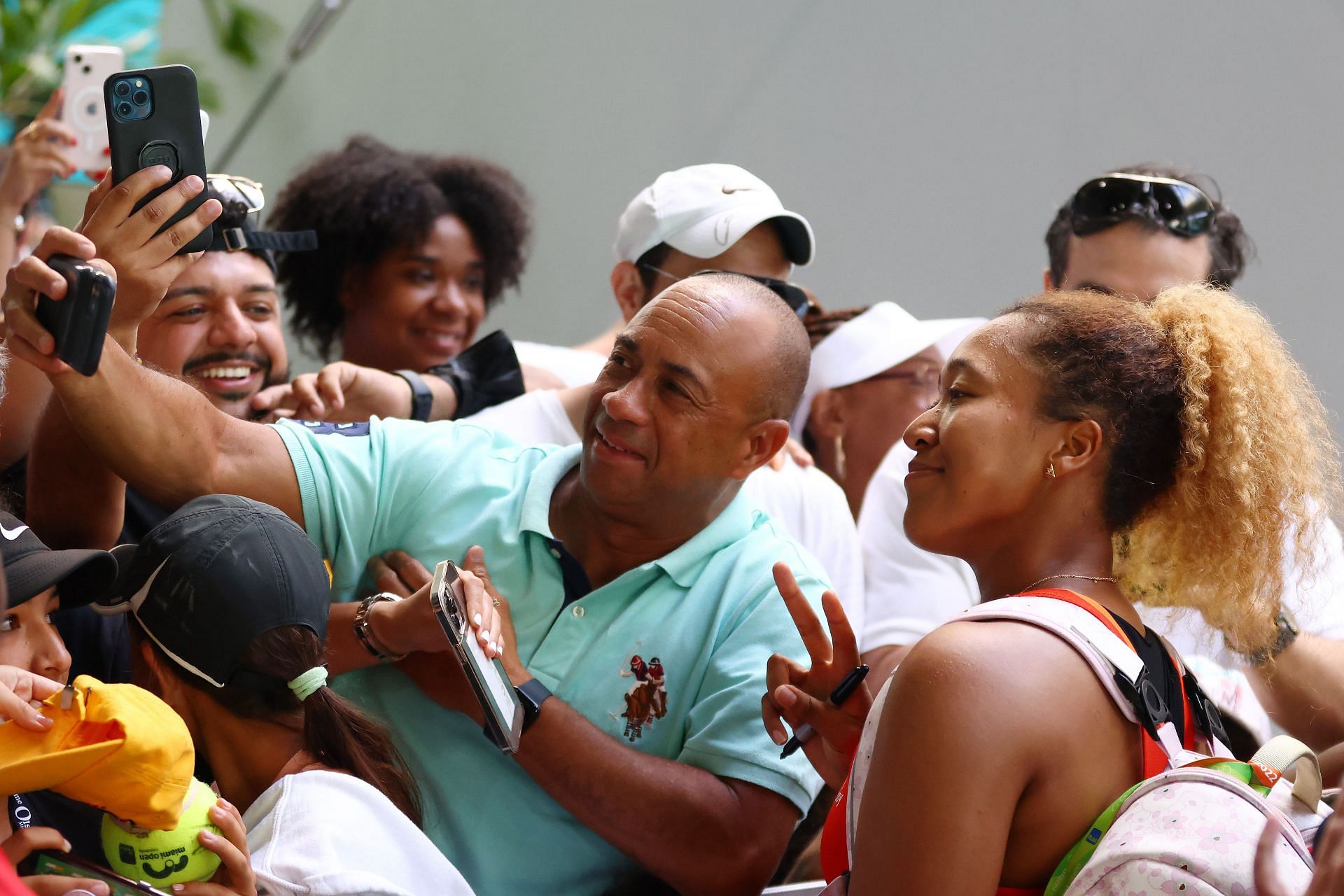 Naomi Osaka takes a selfie with a fan after her win against Belinda Bencic in the semifinals of the 2022 Miami Open.