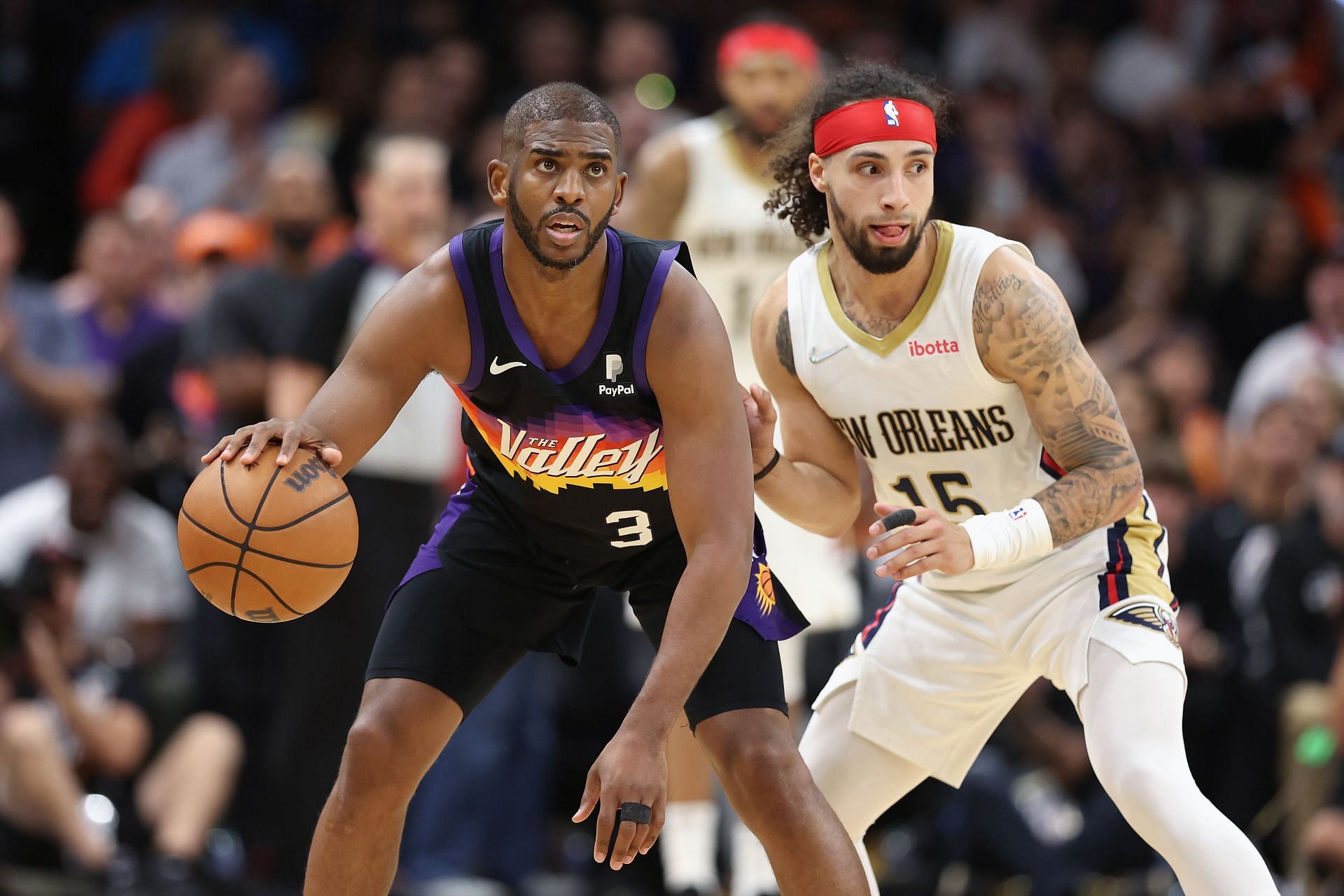 Chris Paul of the Phoenix Suns handles the ball against Jose Alvarado of the New Orleans Pelicans.