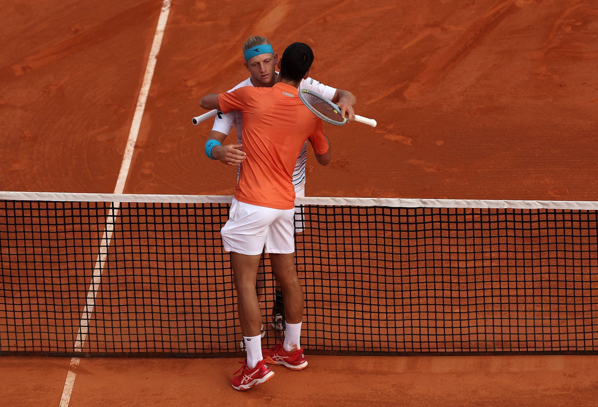 Djokovic and Davidovich Fokina embrace after their match at the 2022 Rolex Monte-Carlo Masters