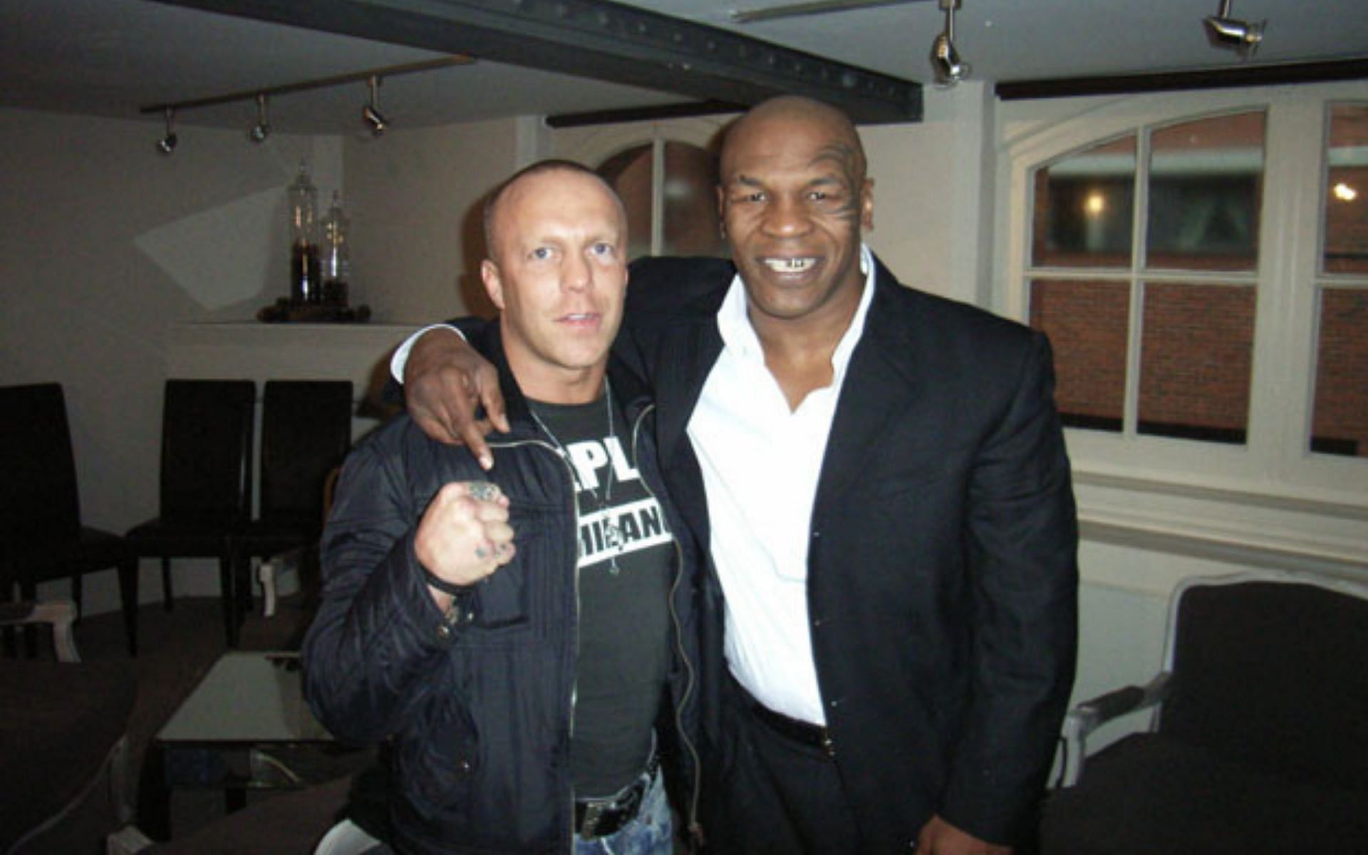 Ramon Dekkers (left) along with Mike Tyson (right) [Image via. The AX Forum]