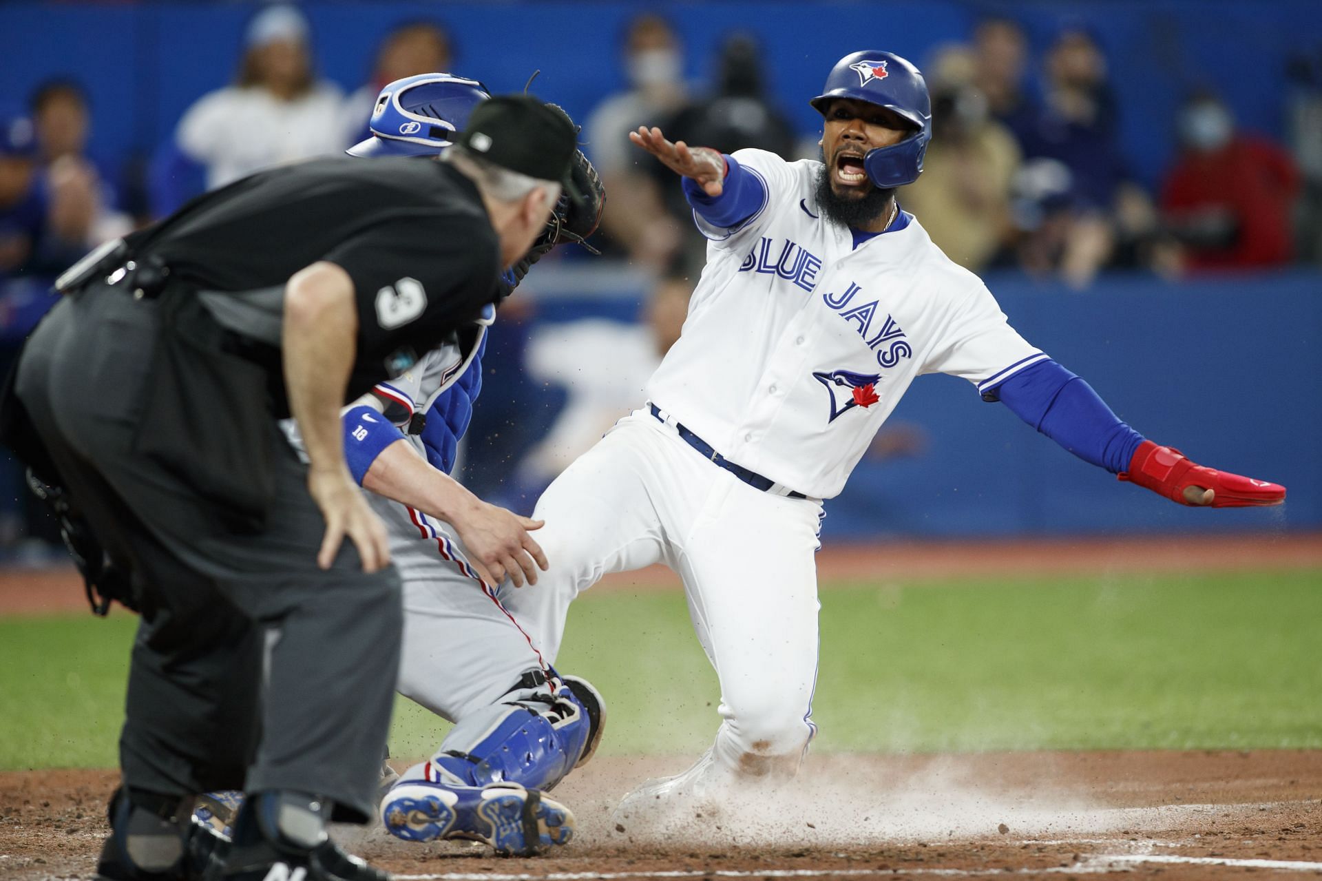 Teoscar Hernandez sliding to home plate