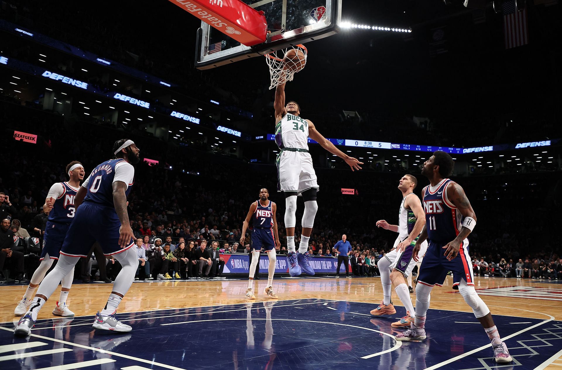 Giannis Antetokounmpo scores off a dunk