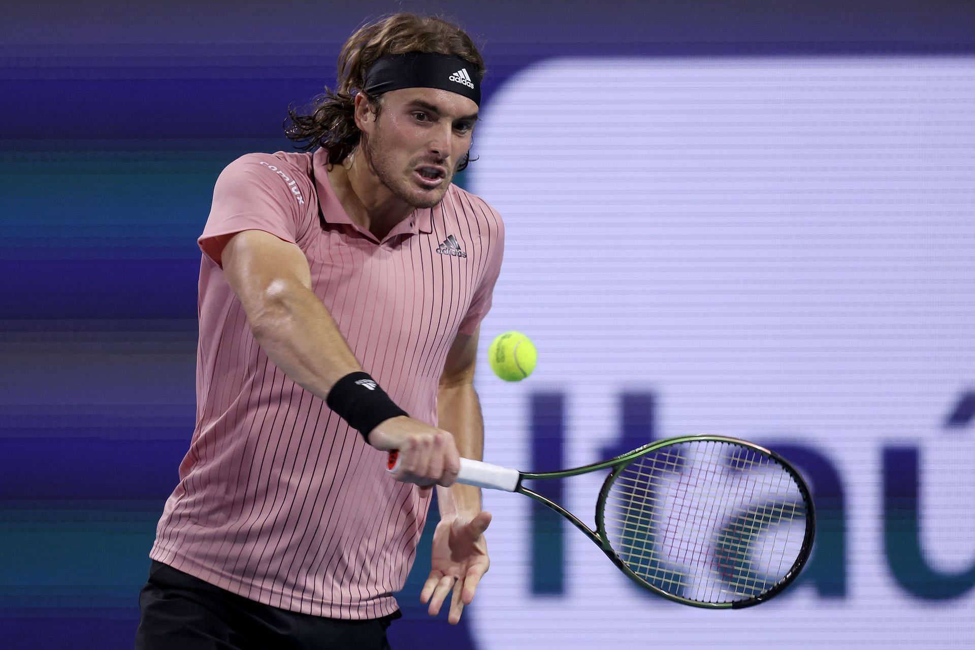 Tsitsipas plays a backhand at the 2022 Miami Open