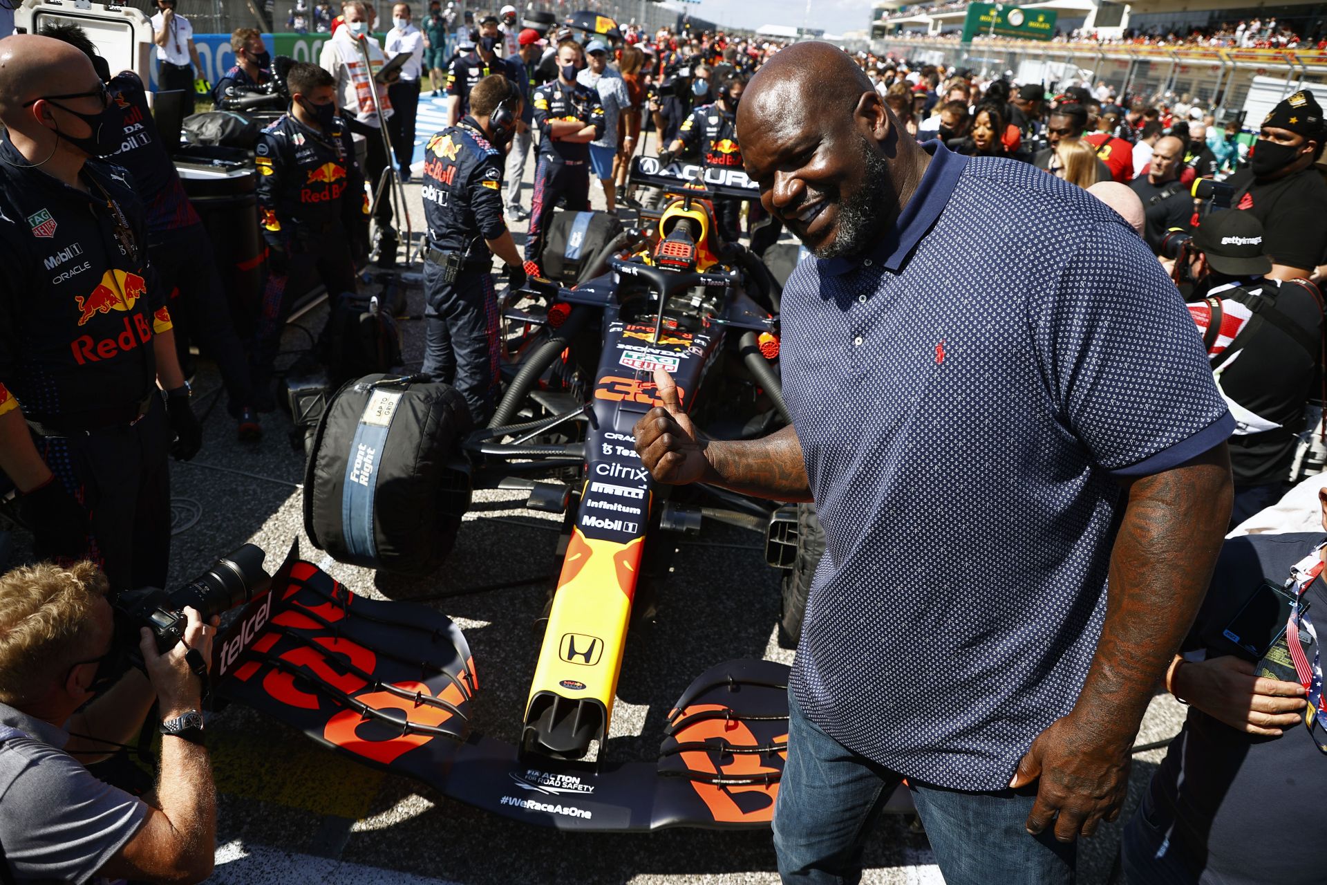 Shaquille O'Neal poses for a photo with the car of Max Verstappen of Netherlands and Red Bull Racing on the grid before the F1 Grand Prix of USA at Circuit of The Americas on October 24, 2021 in Austin, Texas.