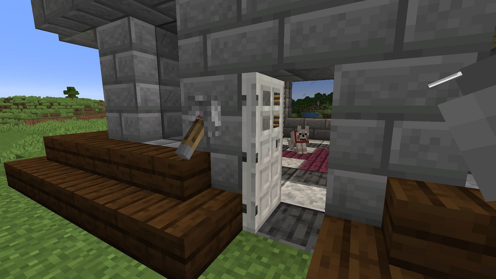 An iron door on a base opened using a lever (Image via Minecraft)