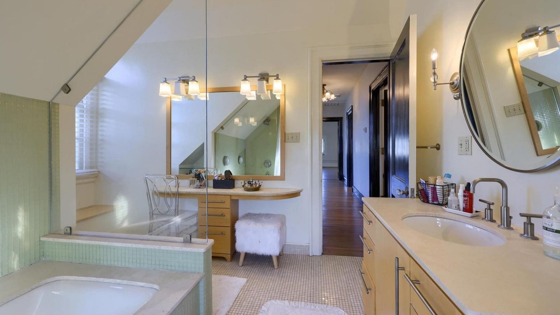 Luxury bath with double vanity, tile floors, travertine, tile shower, and tub (Image via Redfin)