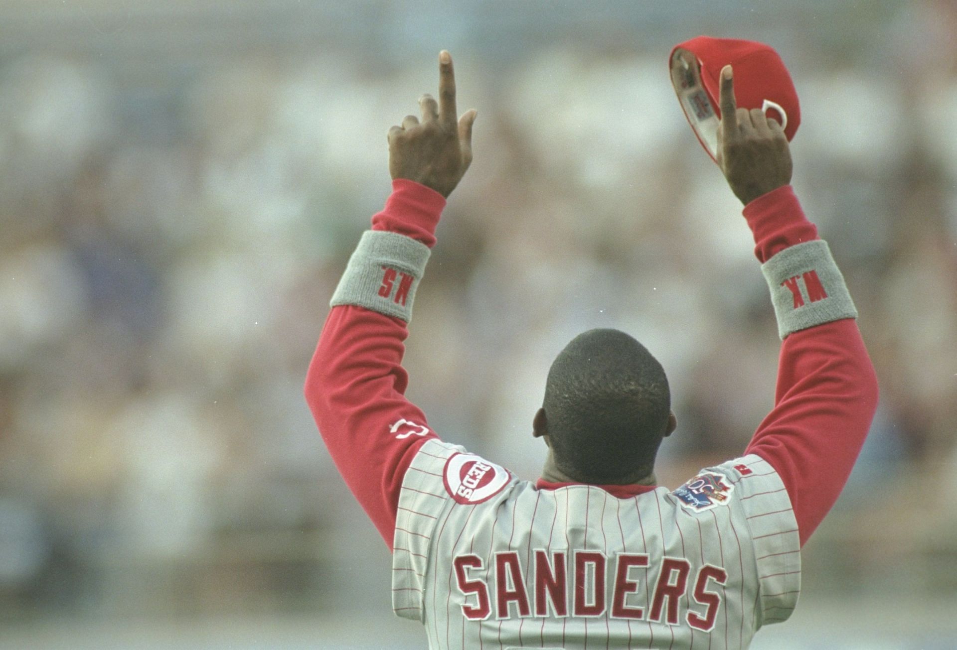 Outfielder Deion Sanders of the Cincinnati Reds boasts to the crowd during a game against the Los Angeles Dodgers