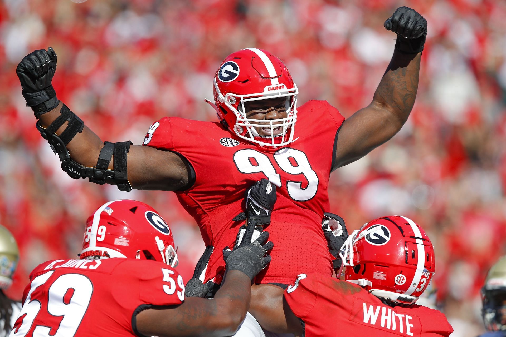 Jordan Davis #99 of the Georgia Bulldogs reacts after rushing in for a touchdown during the first half against the Charleston Southern Buccaneers at Sanford Stadium on November 20, 2021 in Athens, Georgia.