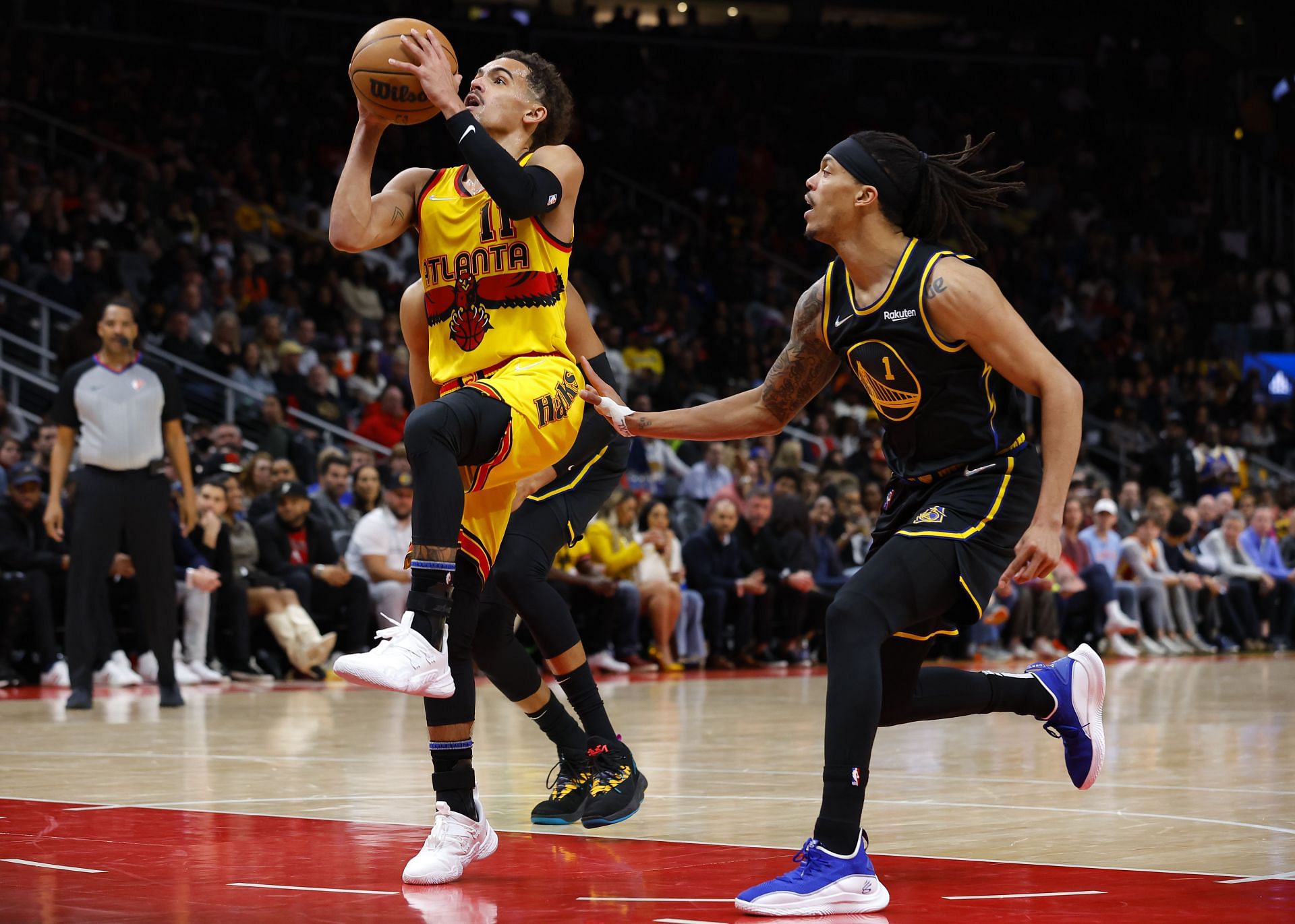 Trae Young #11 of the Atlanta Hawks goes up for a shot as Damion Lee #1 of the Golden State Warriors defends