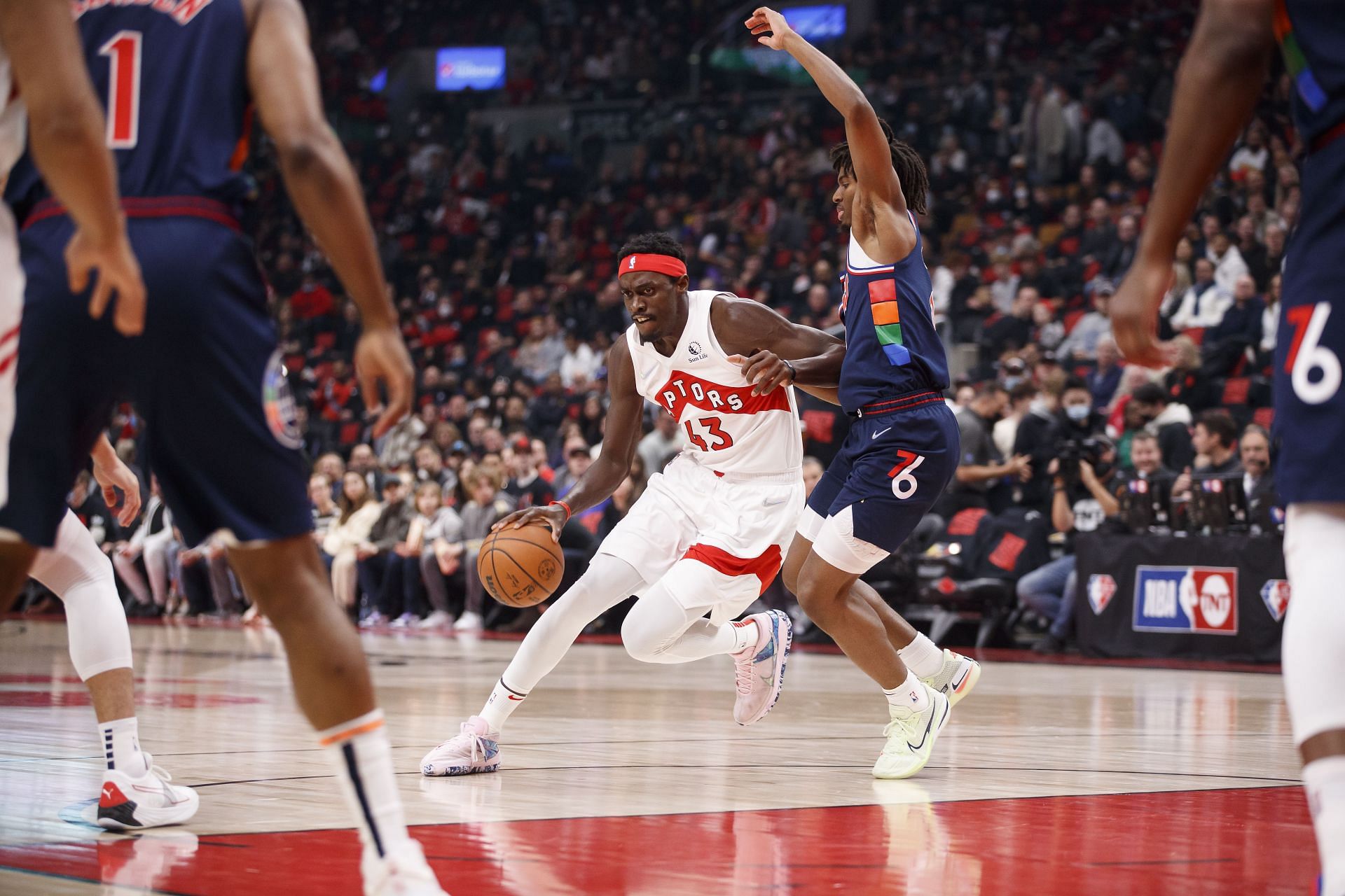 Pascal Siakam No. 43 of the Toronto Raptors dribbles against Tyrese Maxey No. 0 of the Philadelphia 76ers.