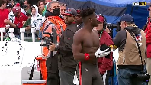 The receiver taking off his equipment before leaving the field against the Jets.