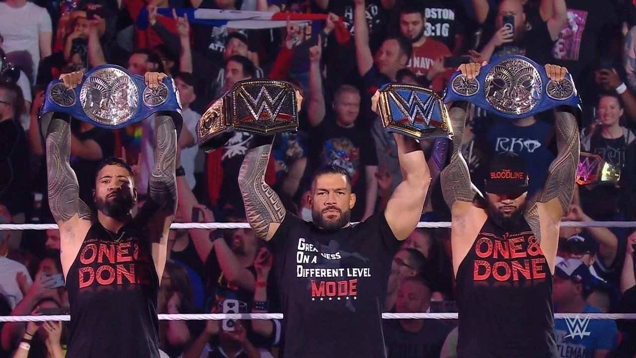 The Tribal Chief standing with The Usos