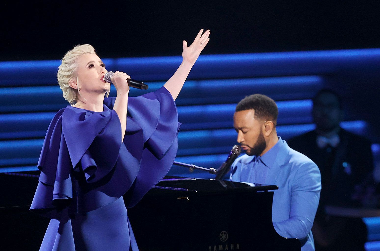 Mika Newton performs Free alongside John Legend at the 64th annual Grammy Awards (Image via Grammys/ Getty Images)