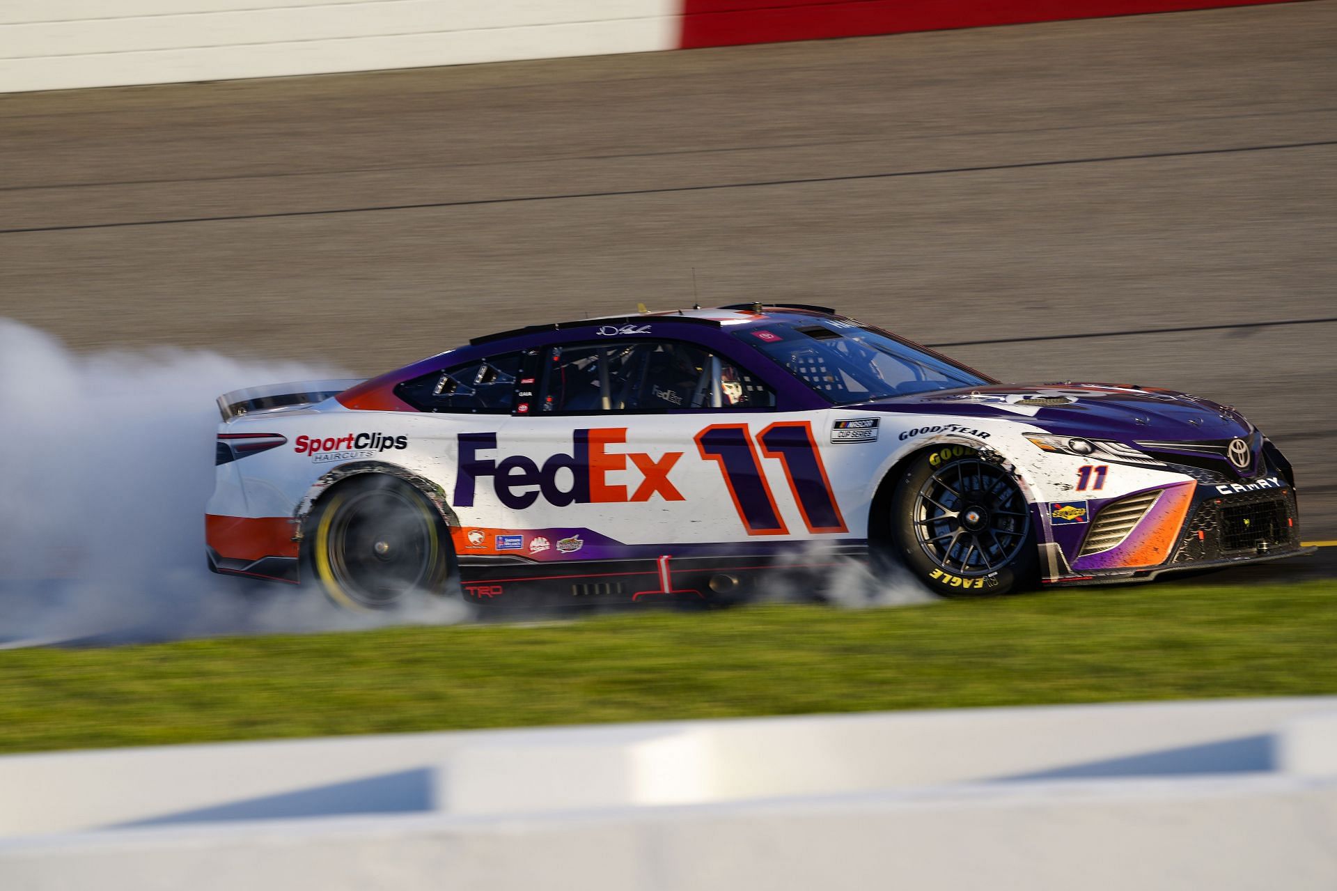 Denny Hamlin celebrates with a burnout after winning the NASCAR Cup Series Toyota Owners 400 at Richmond Raceway.