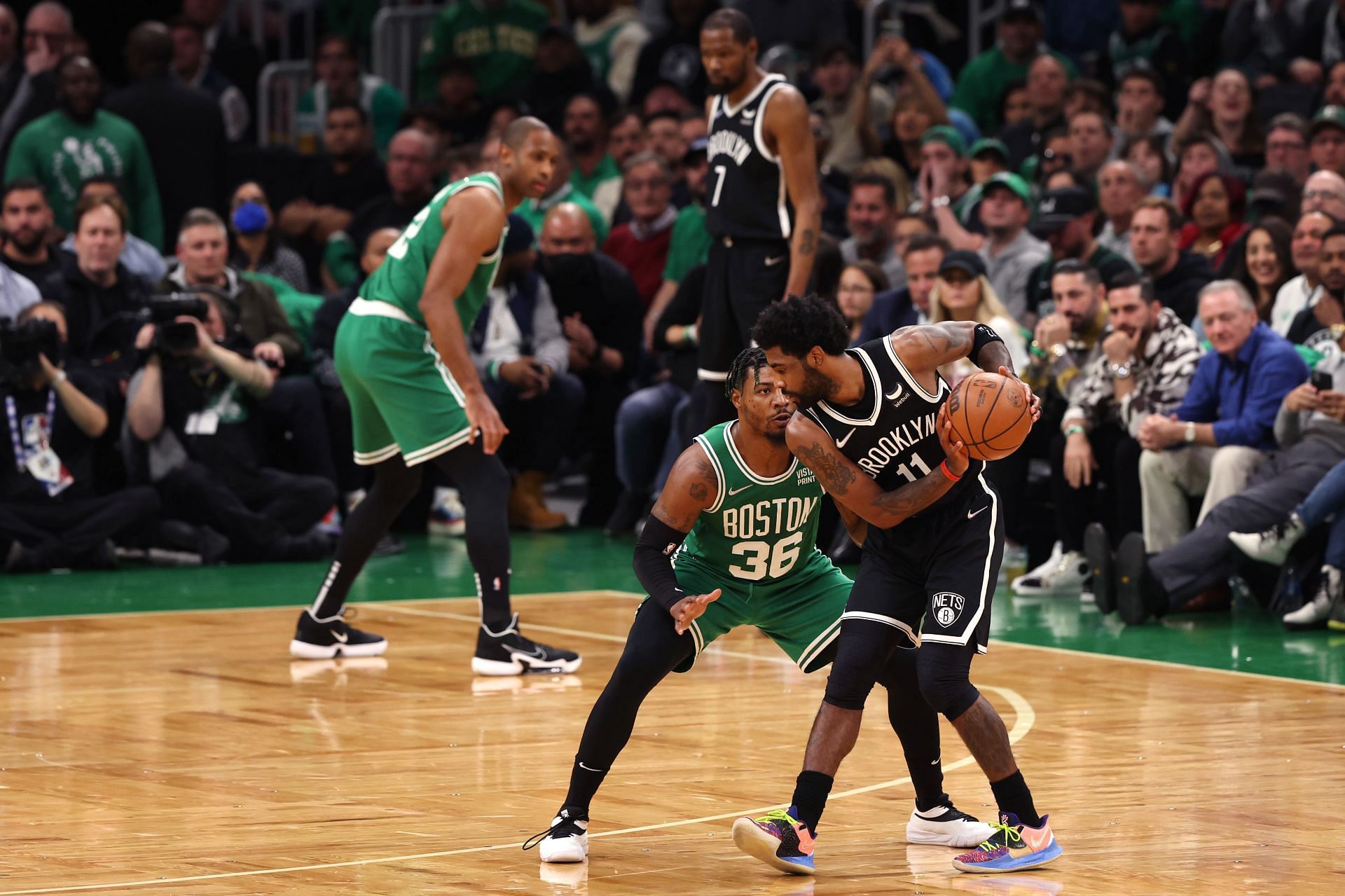 Kyrie Irving being guarded by Marcus Smart