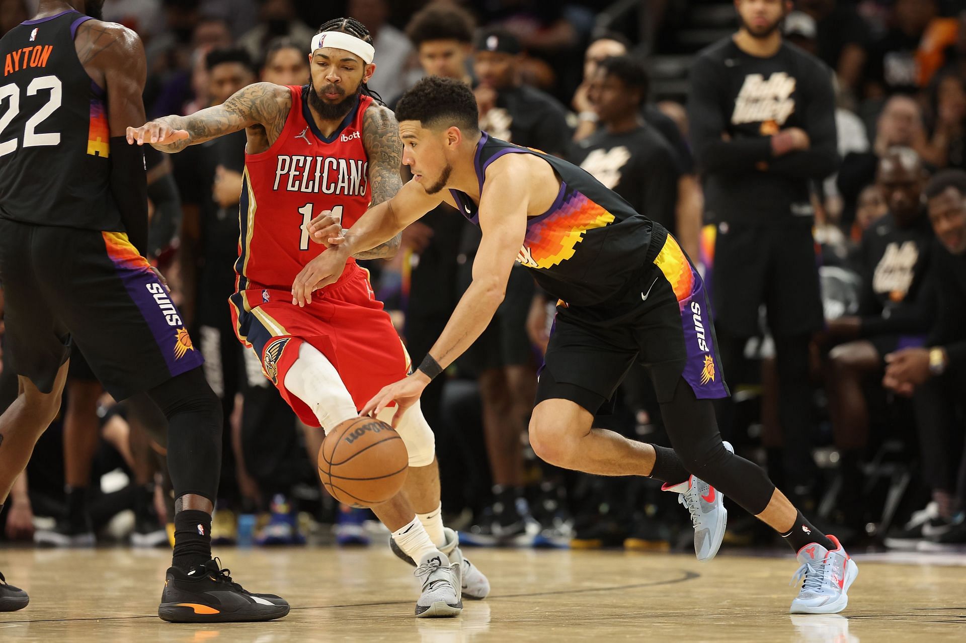 Devin Booker uses a screen to shake off the defender