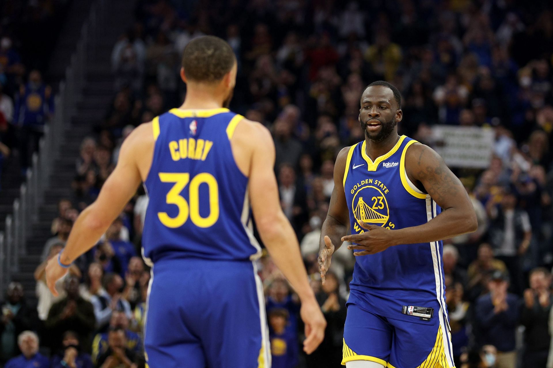 Golden State Warriors Steph Curry and Draymond Green, right