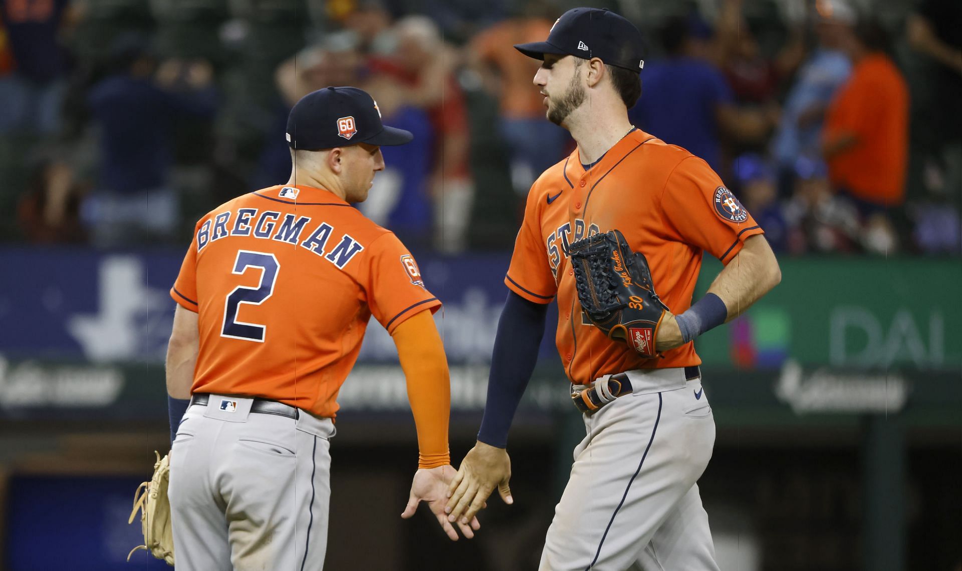 Alex Bregman (left) and Kyle Tucker (left) slap hands with one another after last night&#039;s victory in Arlington.